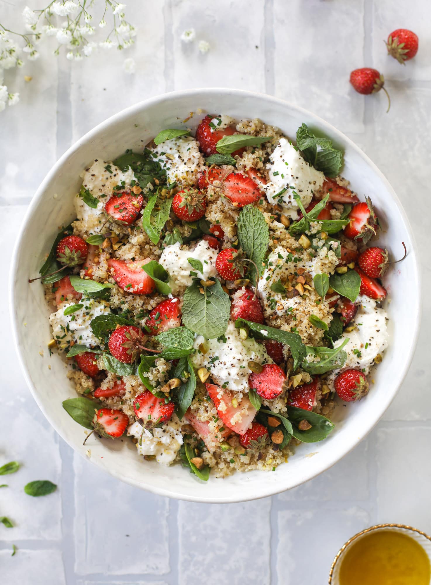 This strawberry quinoa salad is loaded with fresh herbs, burrata cheese and chopped pistachios. Topped with a lemon dressing, it's heavenly!