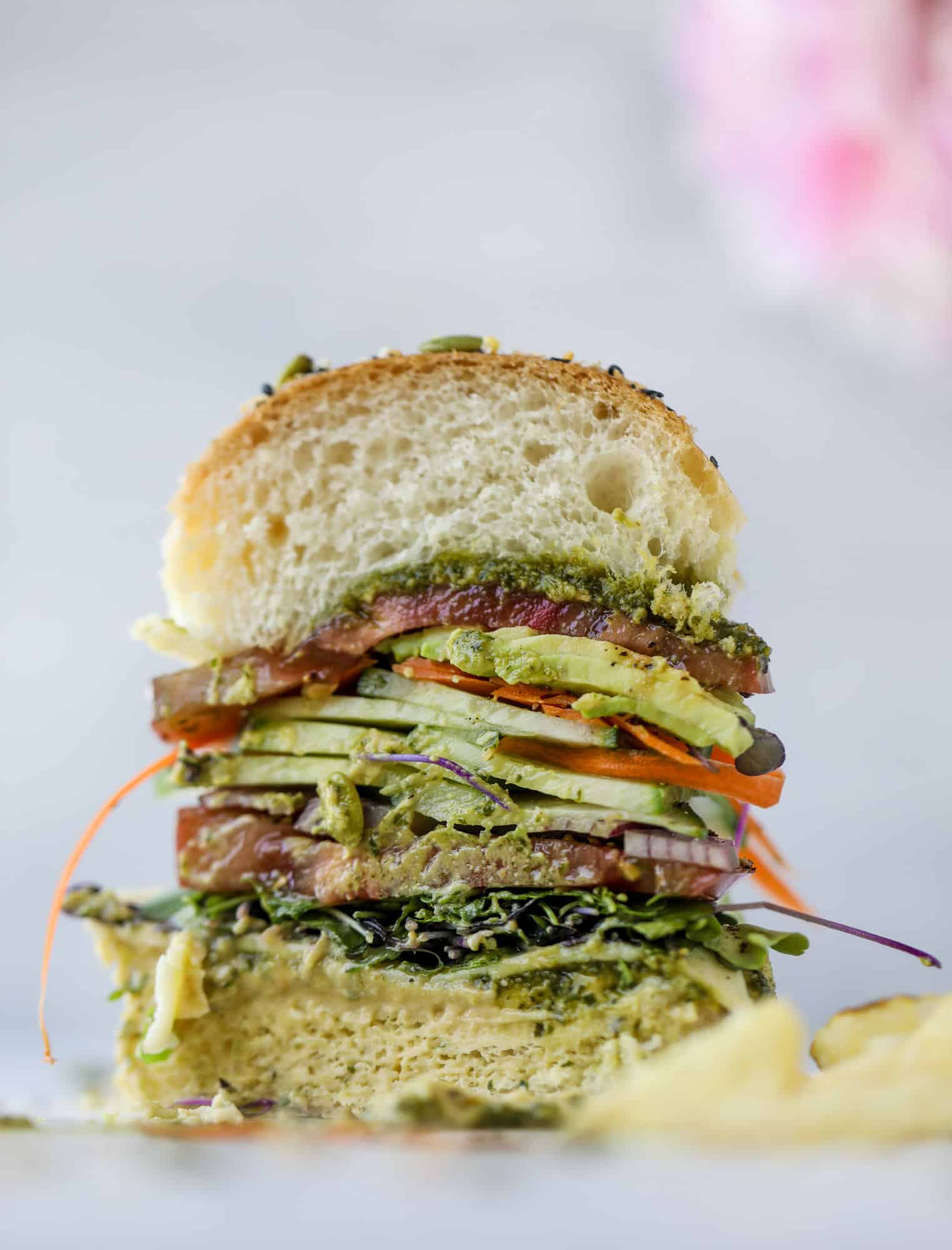 This summer veggie sandwich is full of creamy hummus, fresh pesto and havarti cheese along with tons of sliced, fresh vegetables. Best lunch ever!