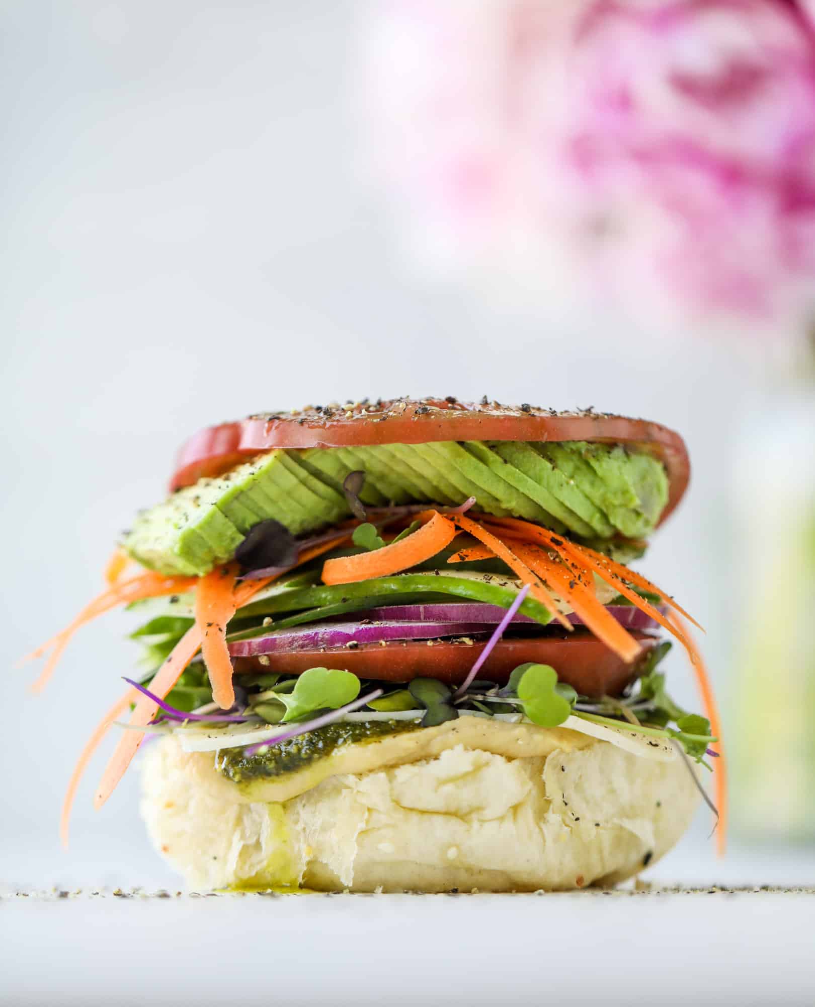 This summer veggie sandwich is full of creamy hummus, fresh pesto and havarti cheese along with tons of sliced, fresh vegetables. Best lunch ever!