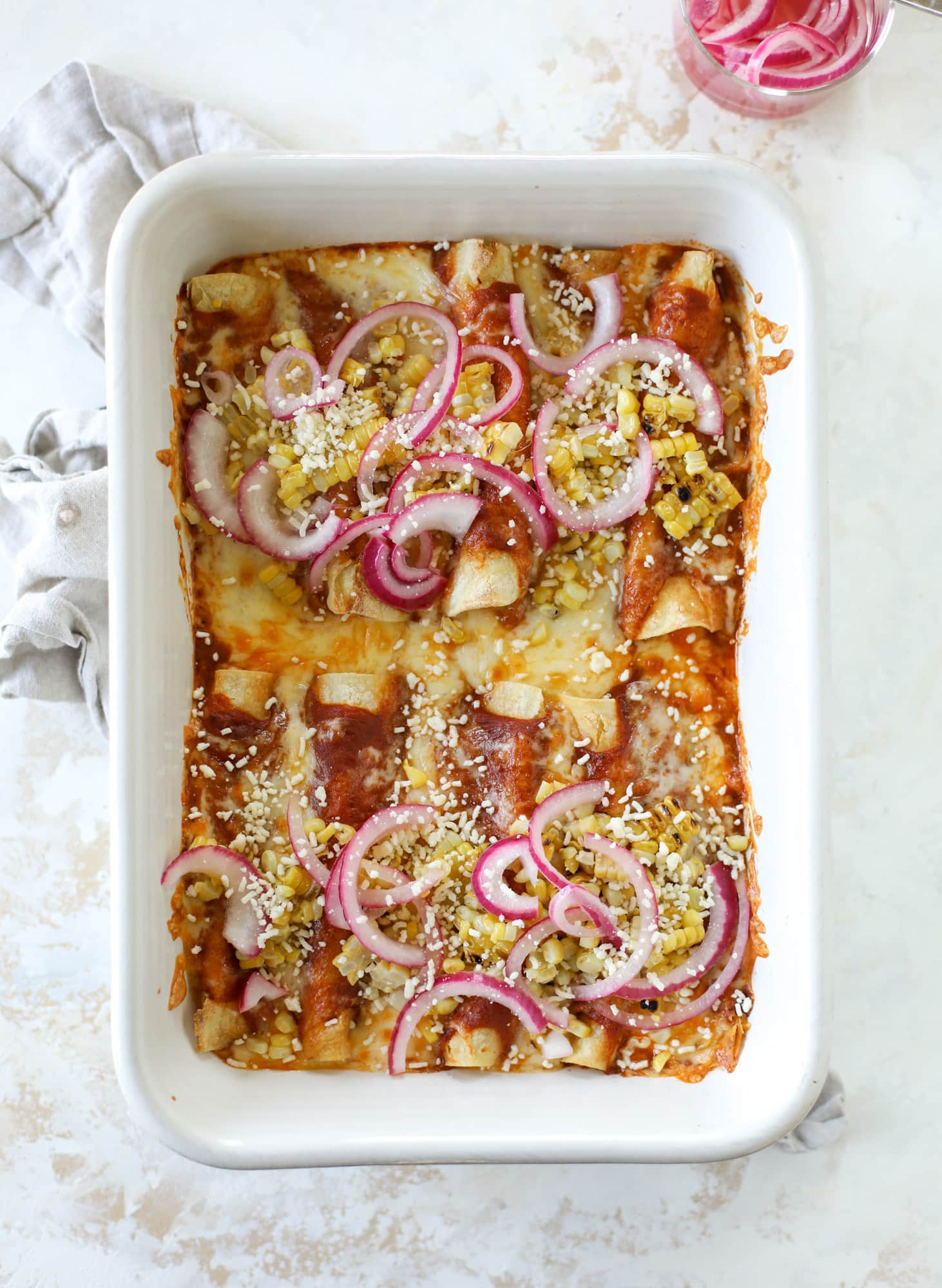 These grilled corn enchiladas are the perfect summer meal! Grilled corn, zucchini, homemade sauce and cheese come together for a flavor explosion!