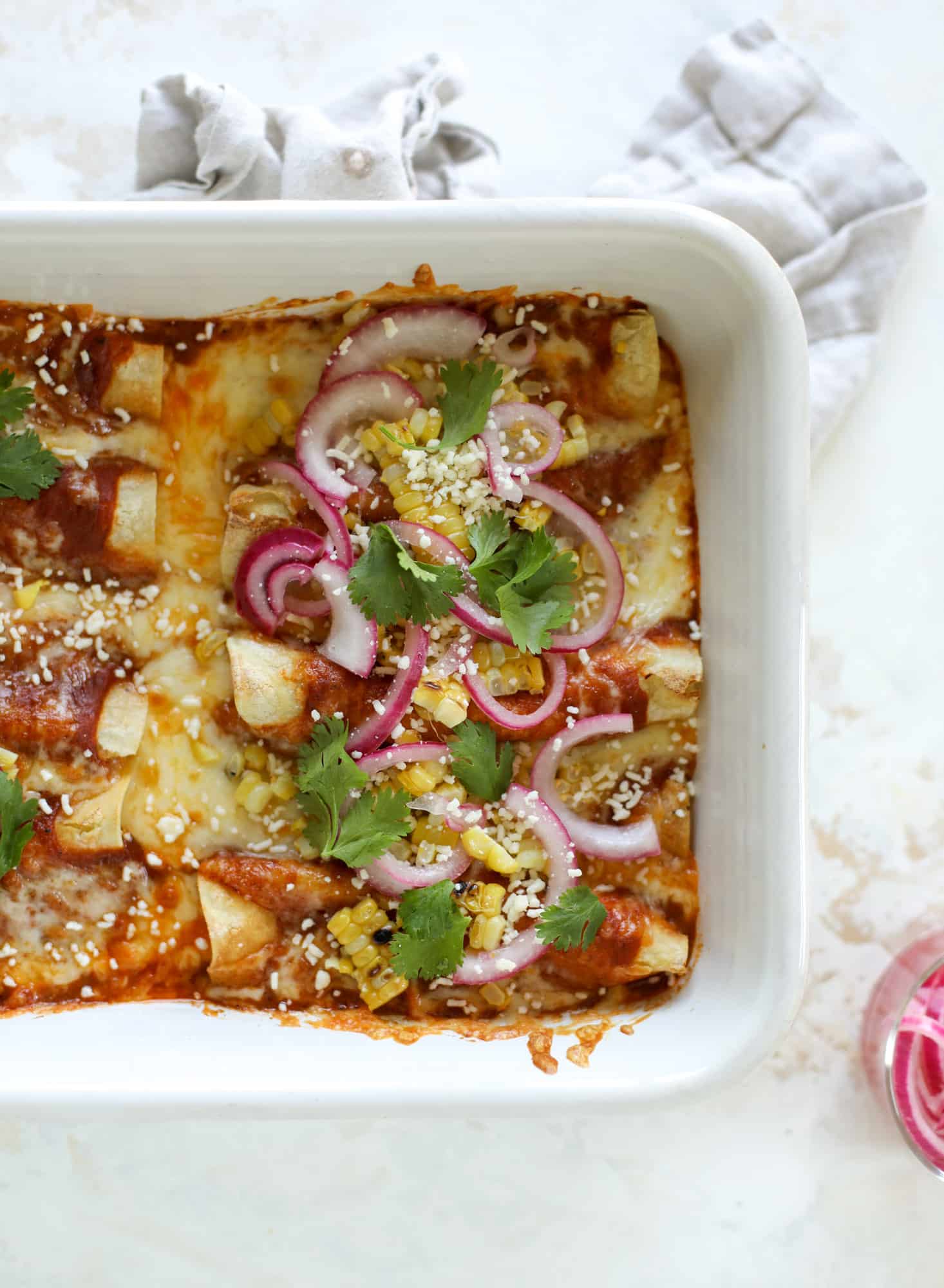 These grilled corn enchiladas are the perfect summer meal! Grilled corn, zucchini, homemade sauce and cheese come together for a flavor explosion!
