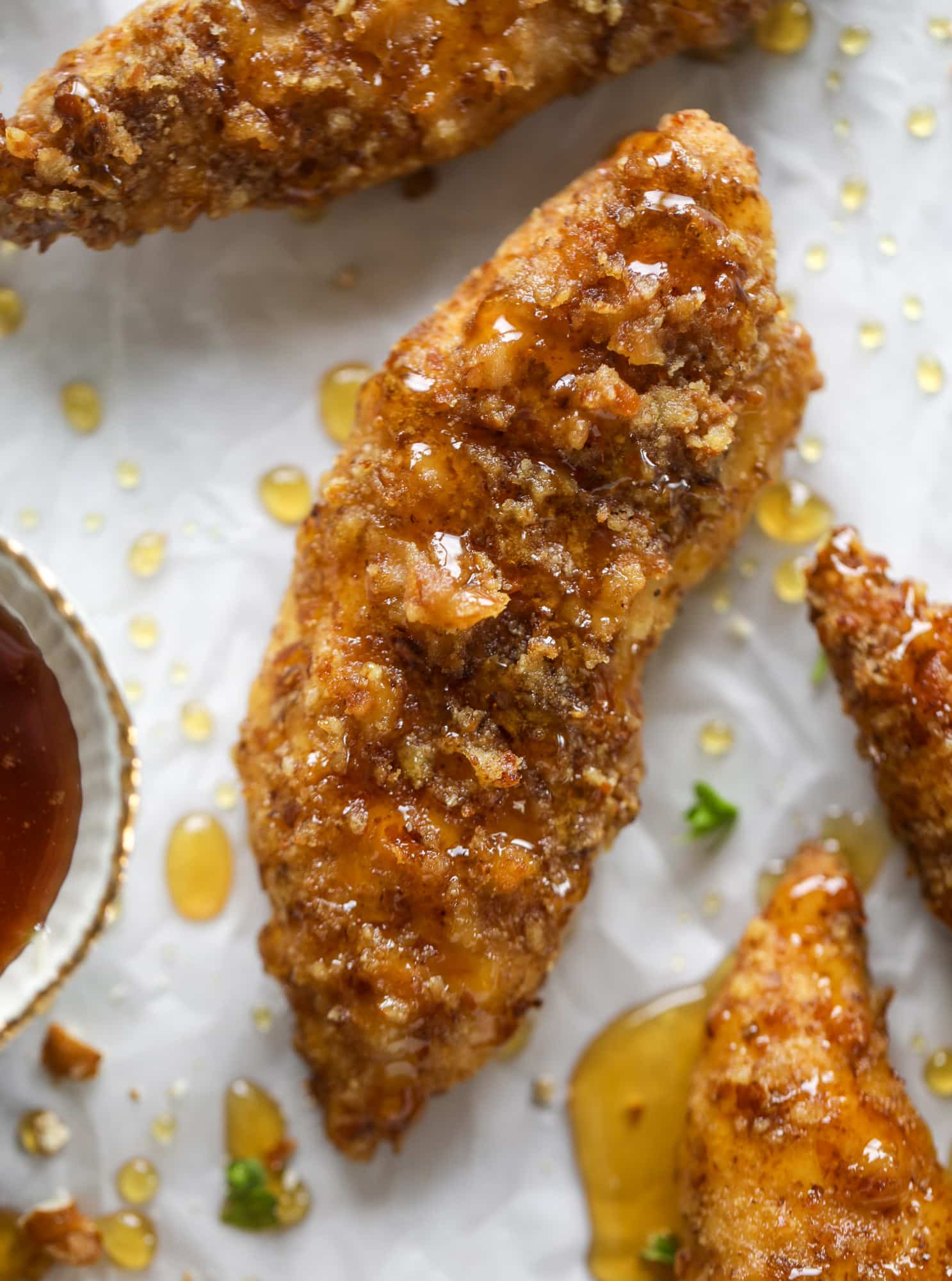 These pretzel crusted chicken fingers are baked, crunchy and ridiculously flavorful. Drizzle with hot honey and dip in house sauce. Yum!
