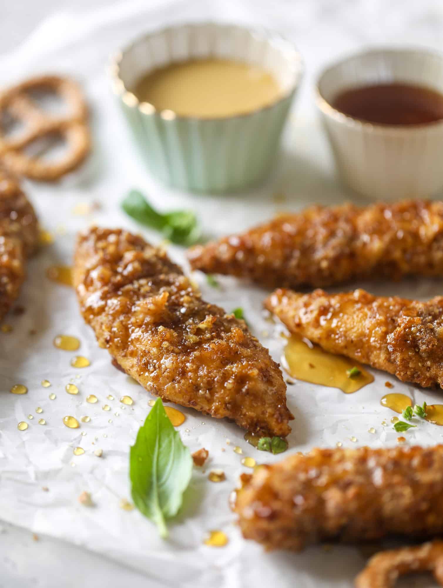 These pretzel crusted chicken fingers are baked, crunchy and ridiculously flavorful. Drizzle with hot honey and dip in house sauce. Yum!