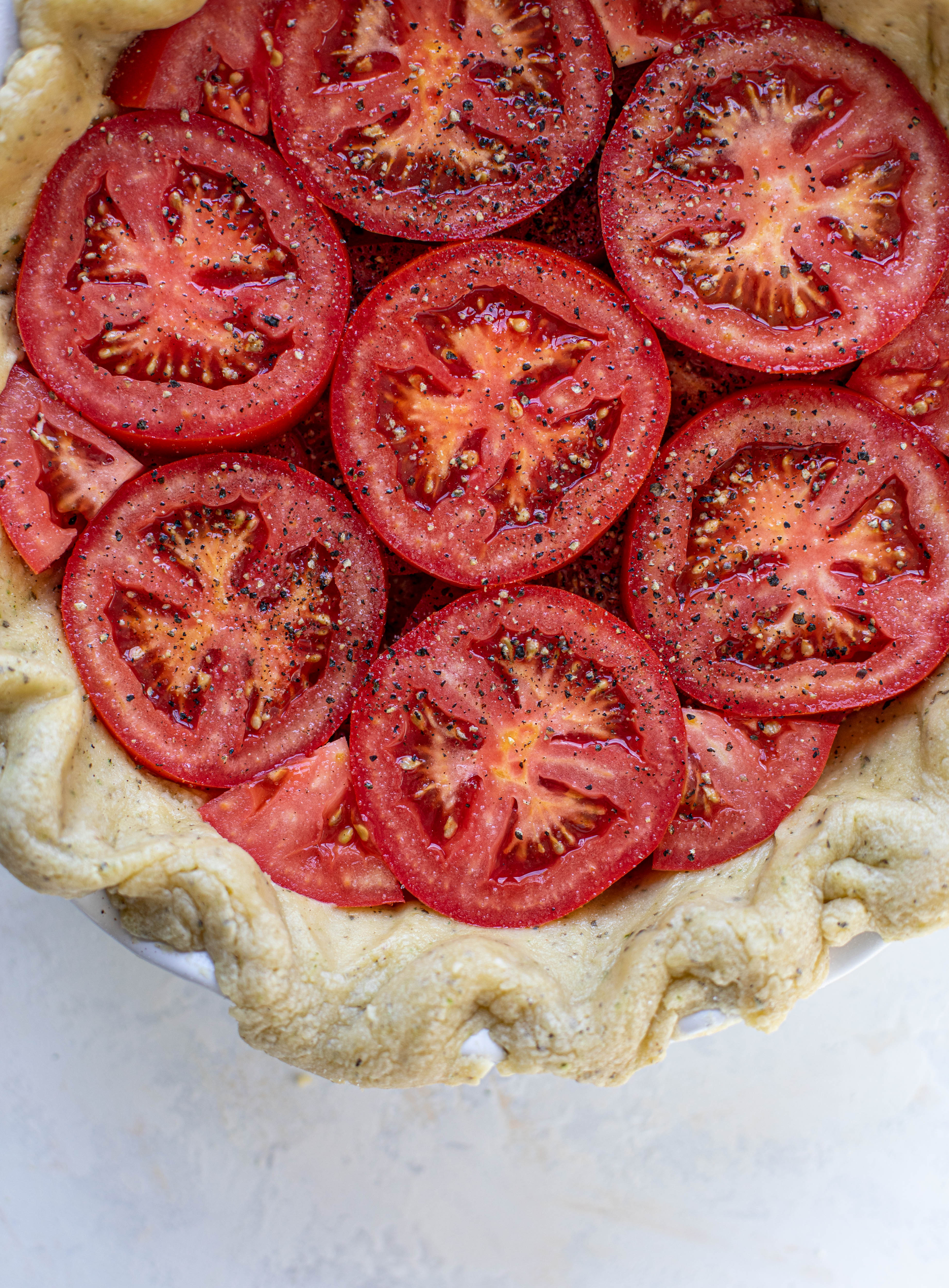 This summer tomato pie is the best dinner ever! Cheddar herb crust, ripe, juicy tomatoes and a cheesy, crunchy layer on top. It's irresistible. 