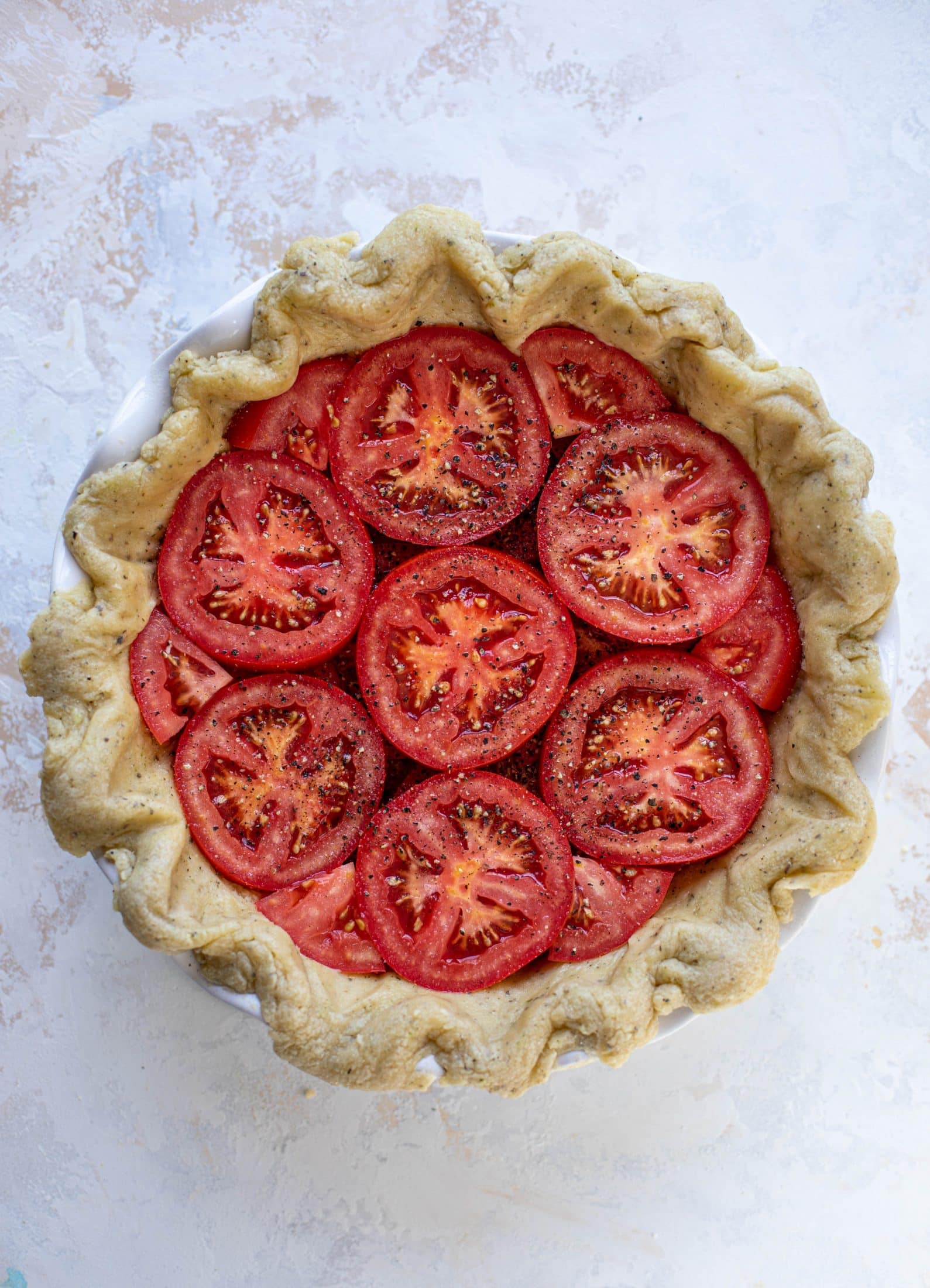 This summer tomato pie is the best dinner ever! Cheddar herb crust, ripe, juicy tomatoes and a cheesy, crunchy layer on top. It's irresistible. 