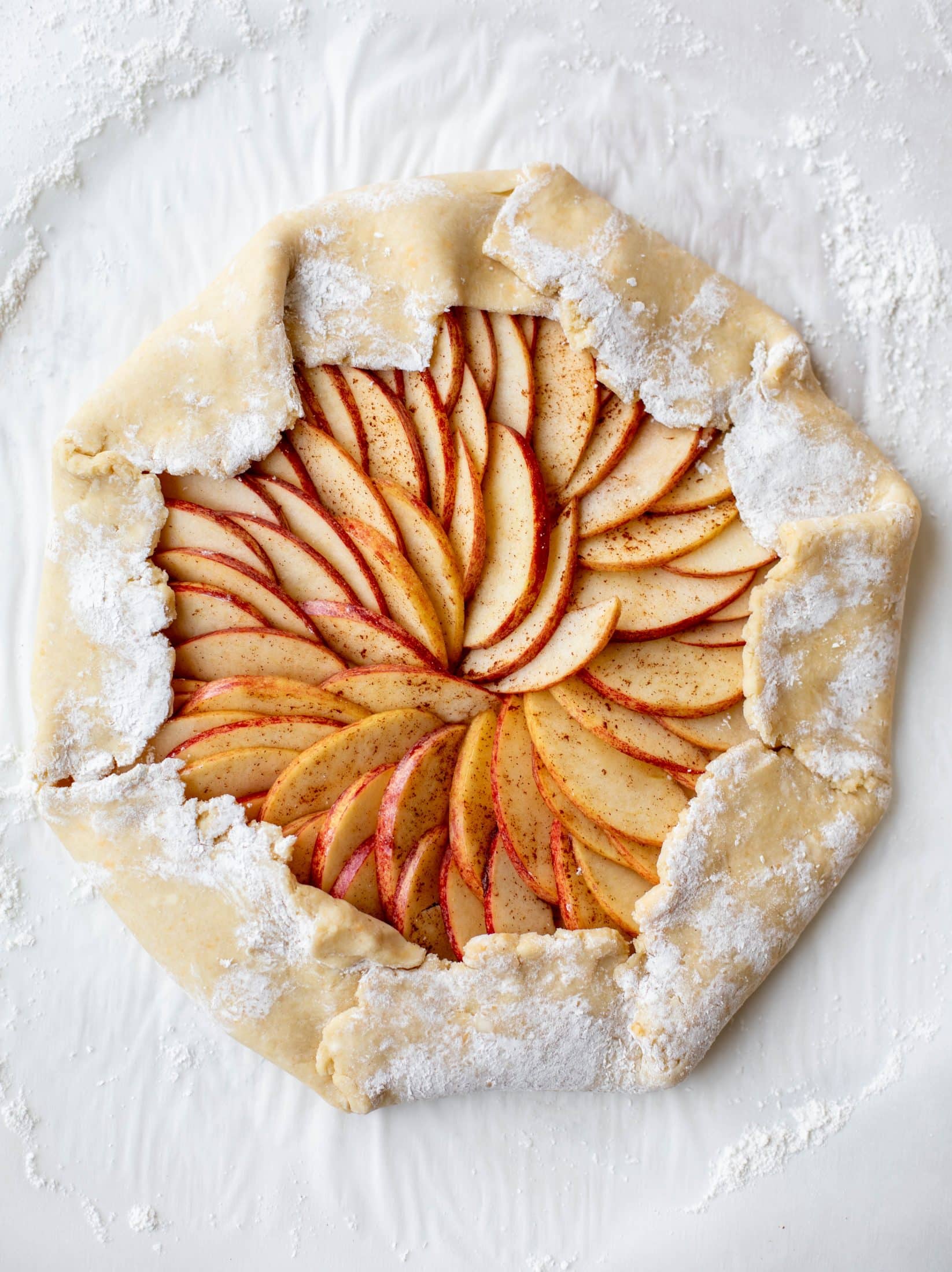 This apple cheddar galette is made with honeycrisp apples, set in a cheddar herb crust and brushed with thyme butter! So delicious and perfect for fall.