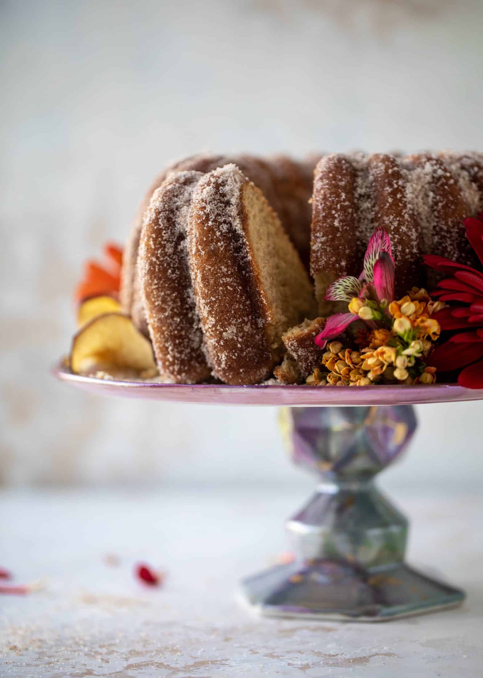 This apple cider donut cake is a huge fall crowd pleaser! Covered in cinnamon sugar and fluffy to perfection. It's incredible!