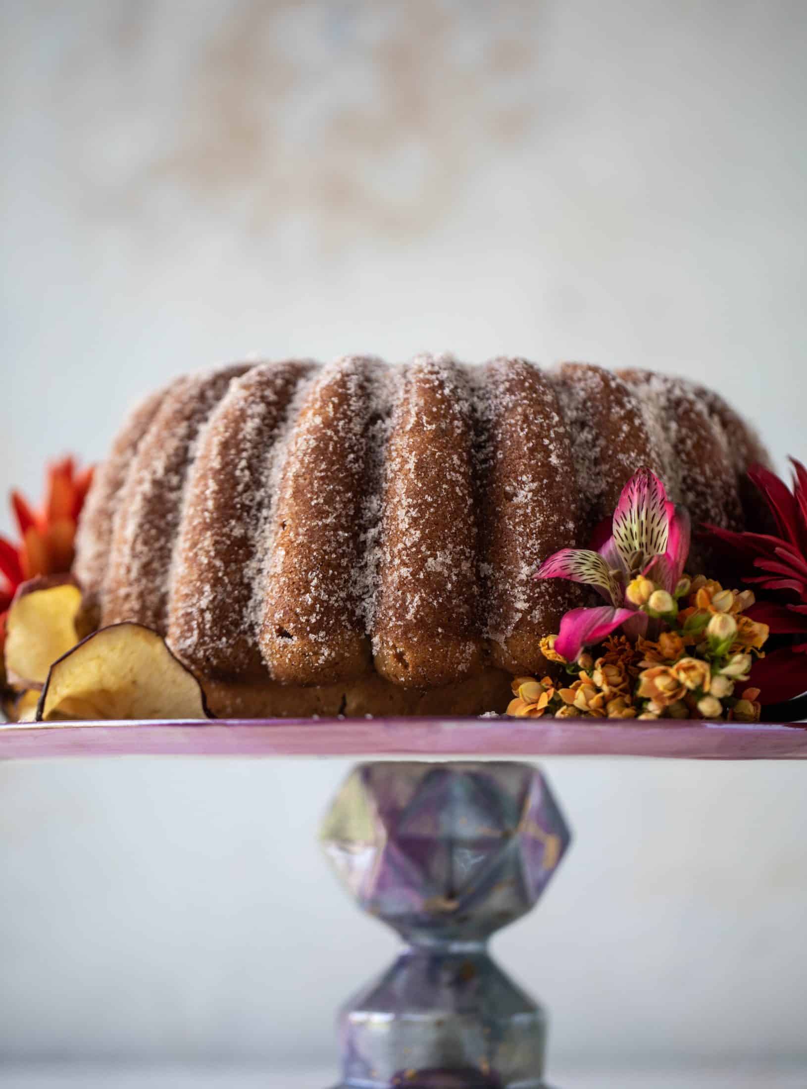 This apple cider donut cake is a huge fall crowd pleaser! Covered in cinnamon sugar and fluffy to perfection. It's incredible!