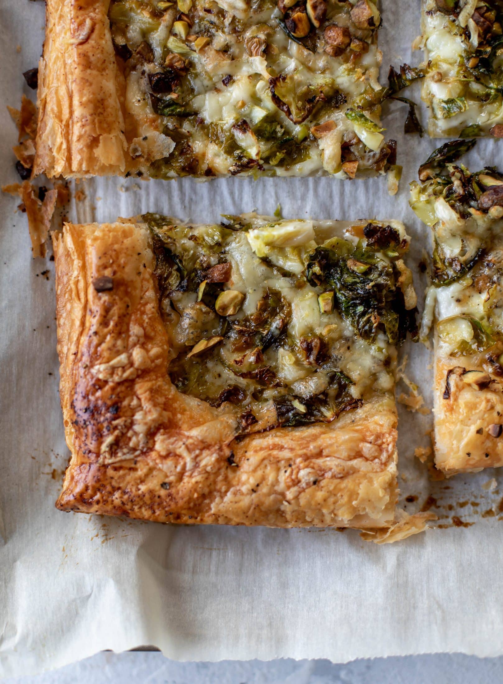 This brussels sprouts tart has a ton of flavor! Melty fontina, sliced brussels and crunchy pistachios all on top of puff pastry. Delish!