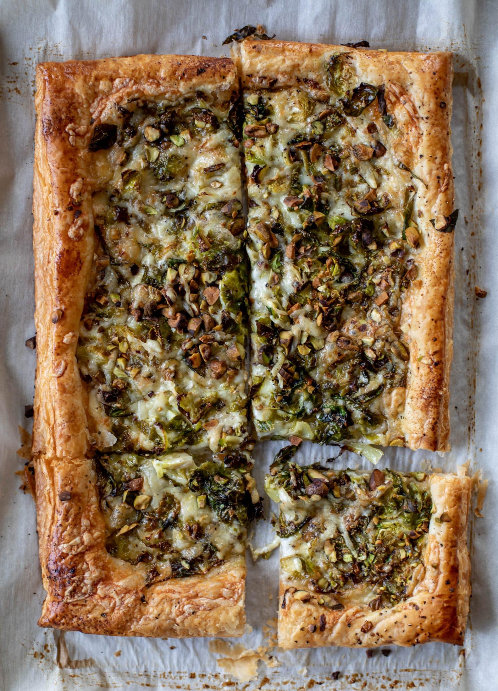 This brussels sprouts tart has a ton of flavor! Melty fontina, sliced brussels and crunchy pistachios all on top of puff pastry. Delish!