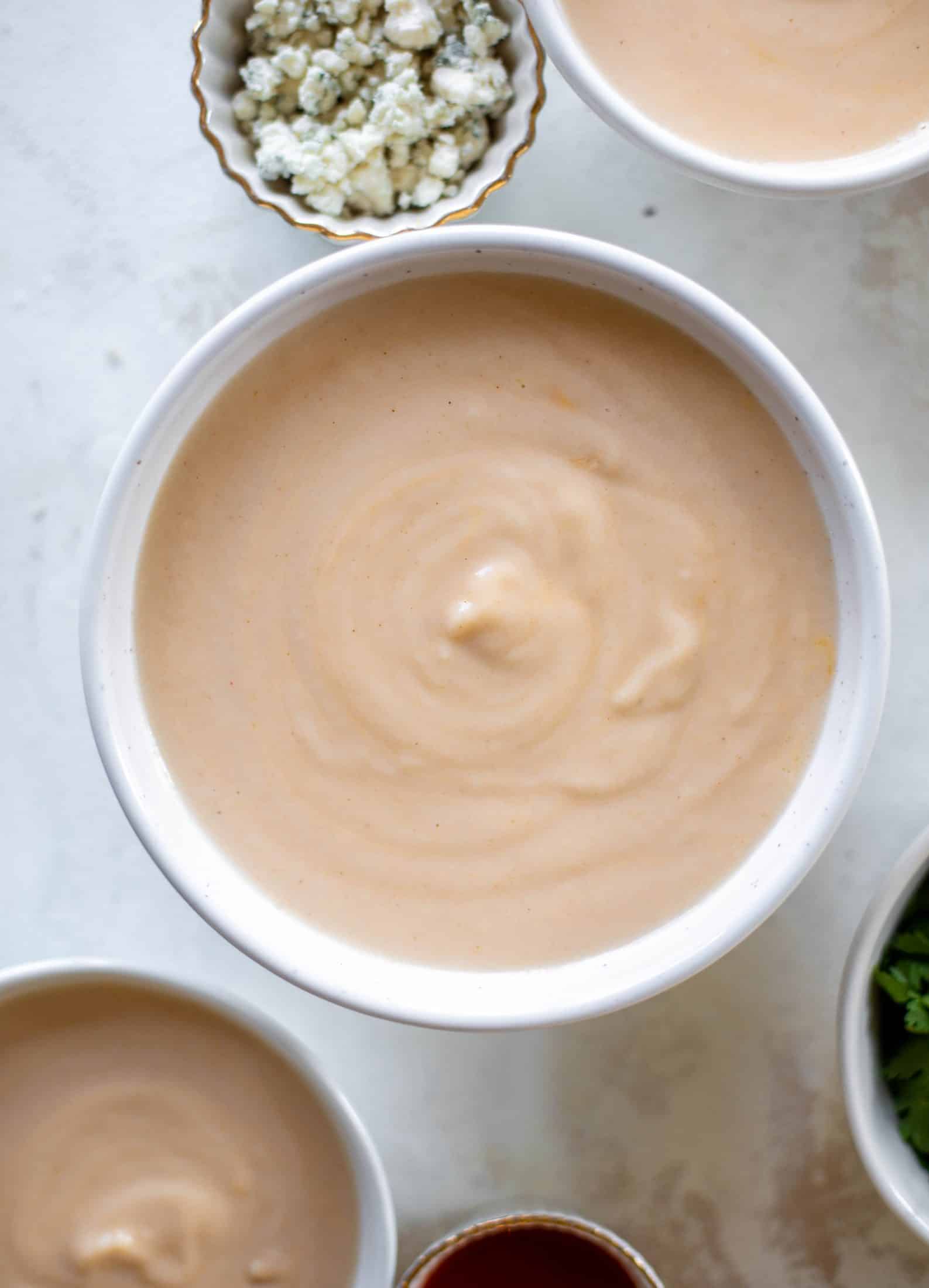 This buffalo cauliflower soup is creamy and decadent and silky smooth! Made with cheddar, wing sauce, blue cheese and all the fixins! 