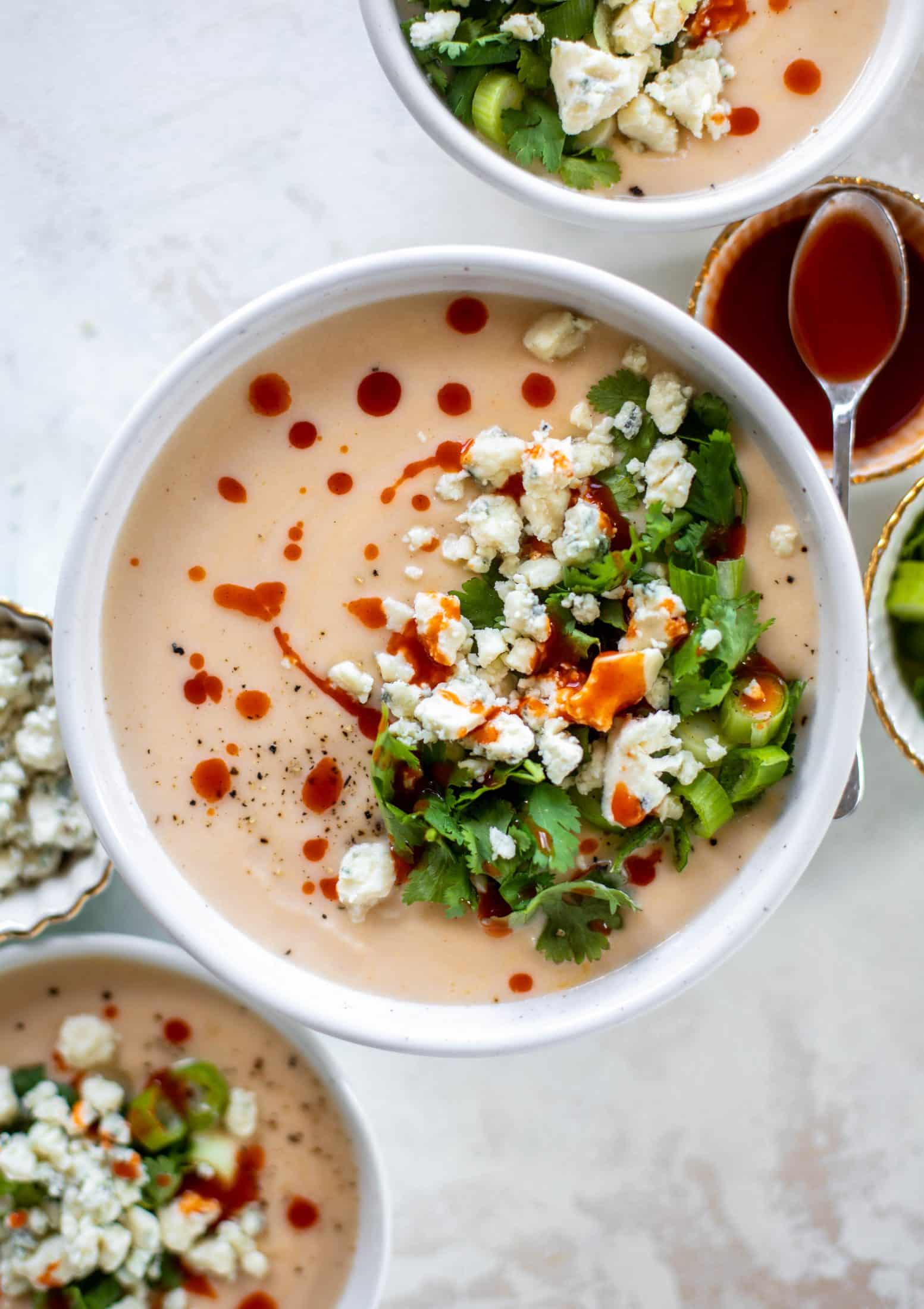 This buffalo cauliflower soup is creamy and decadent and silky smooth! Made with cheddar, wing sauce, blue cheese and all the fixins! 