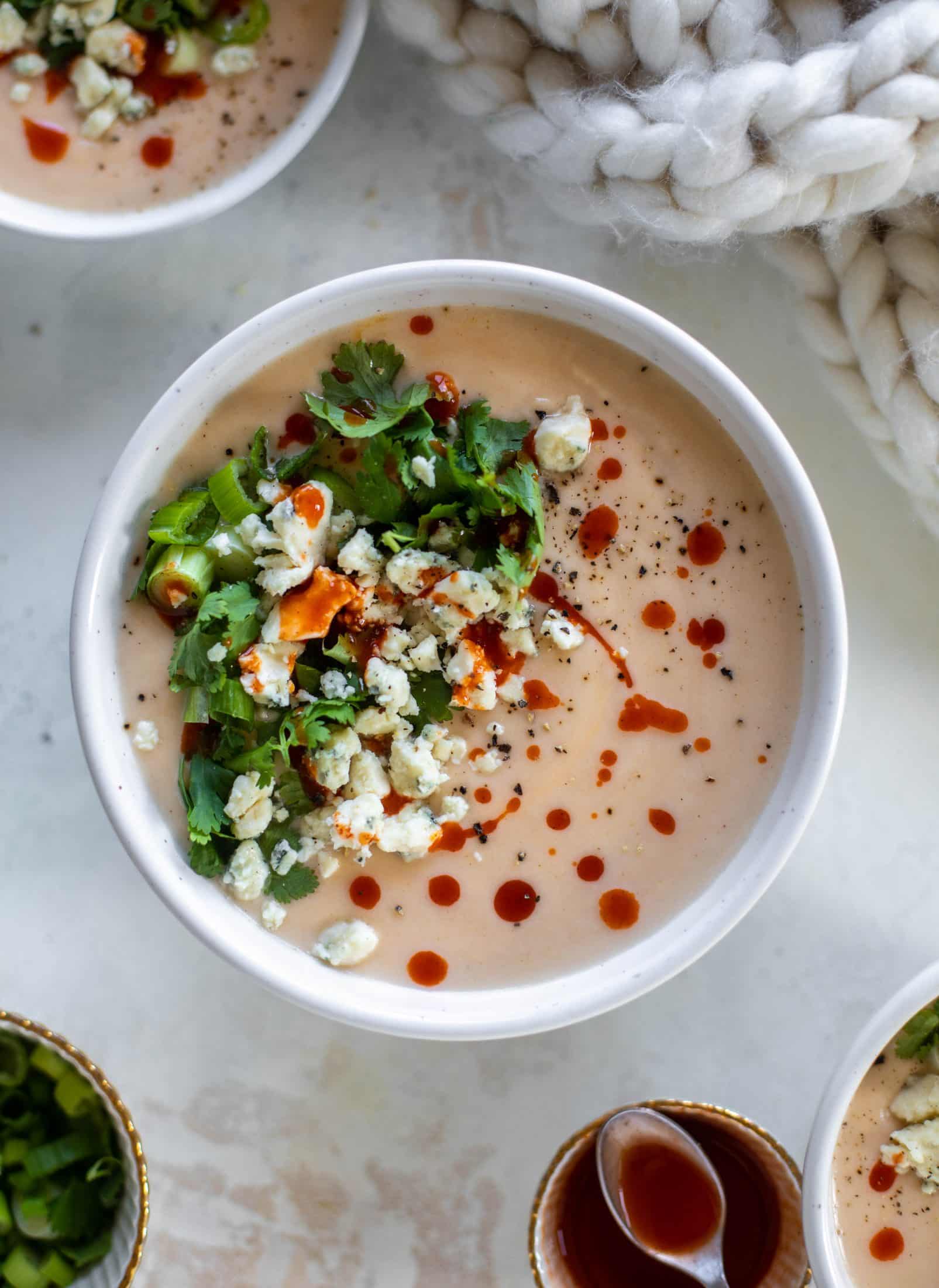 This buffalo cauliflower soup is creamy and decadent and silky smooth! Made with cheddar, wing sauce, blue cheese and all the fixins! 