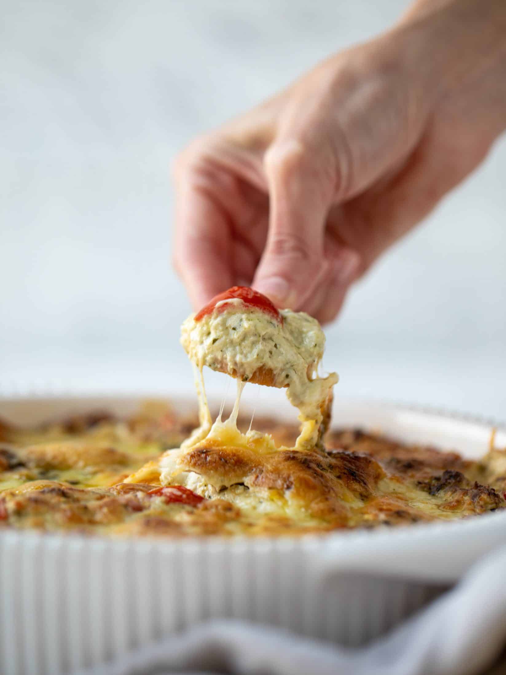 This cheesy pesto chicken dip is a great way to use up your end-of-summer herbs! Lots of delicious smoky flavor and tons of bubbly cheese.
