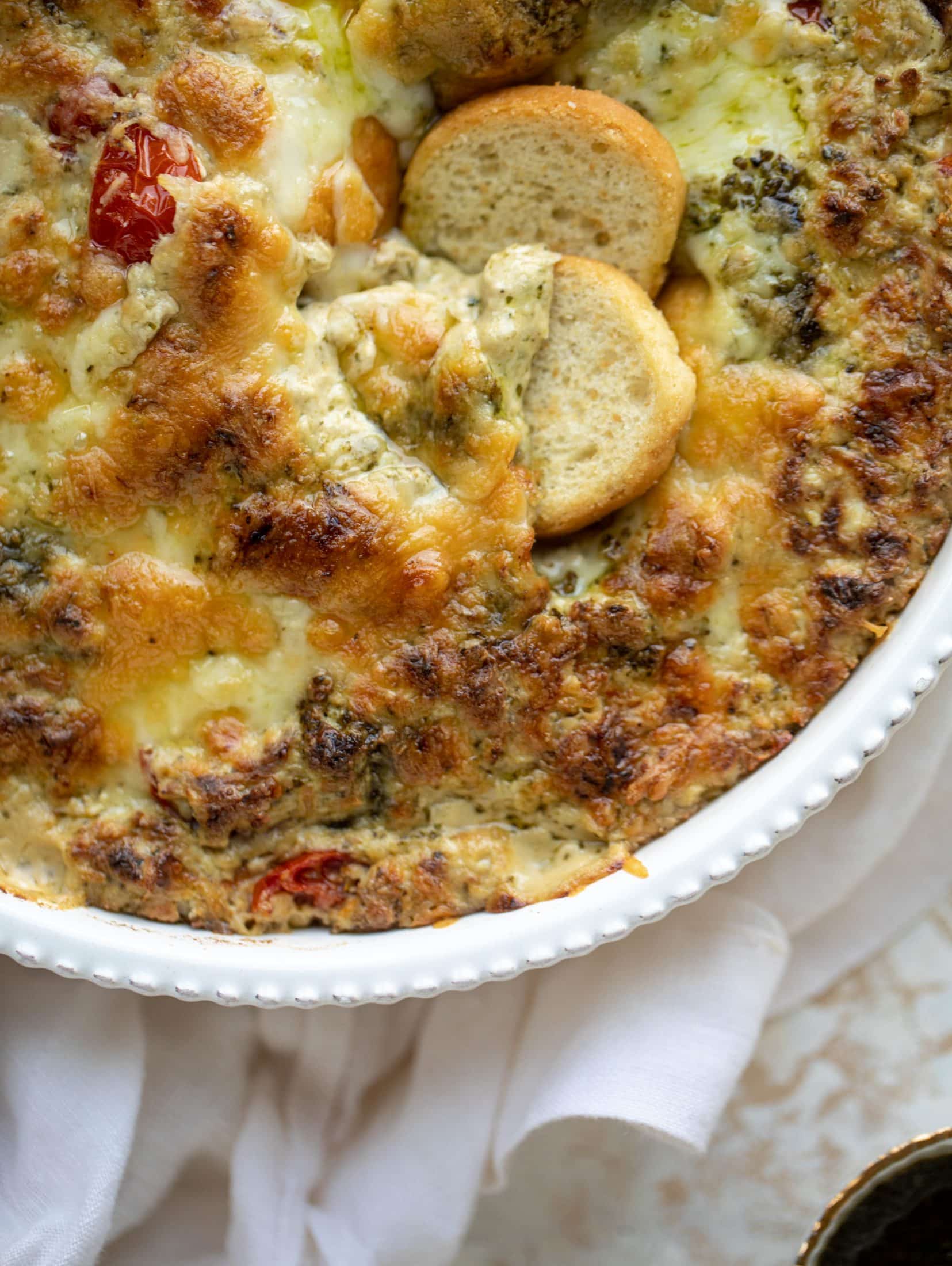 This cheesy pesto chicken dip is a great way to use up your end-of-summer herbs! Lots of delicious smoky flavor and tons of bubbly cheese.