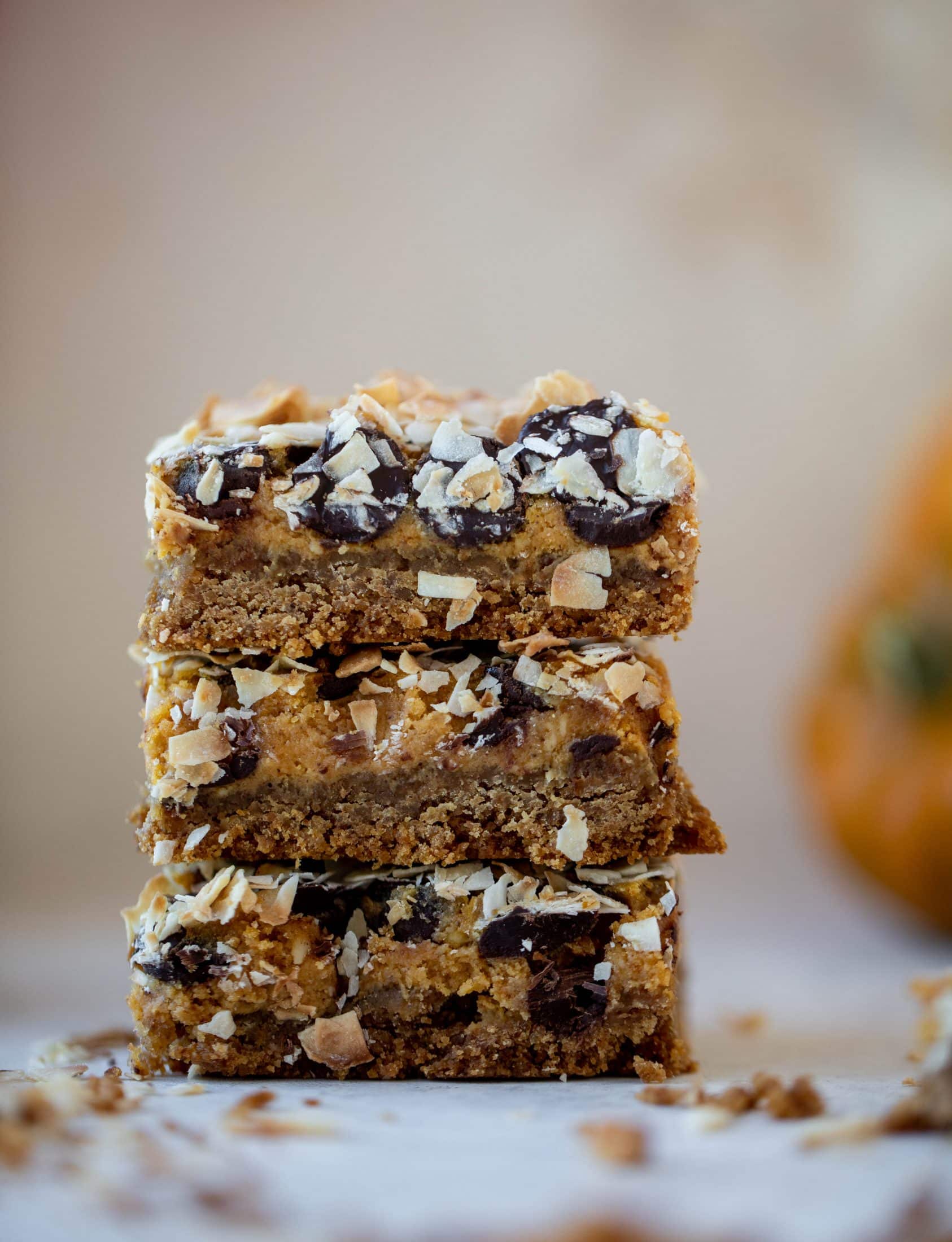 Pumpkin gooey bars are a decadent chocolate, coconut and pumpkin dessert! Crunchy graham crust, gooey pumpkin center and a crisp topping. Yum!