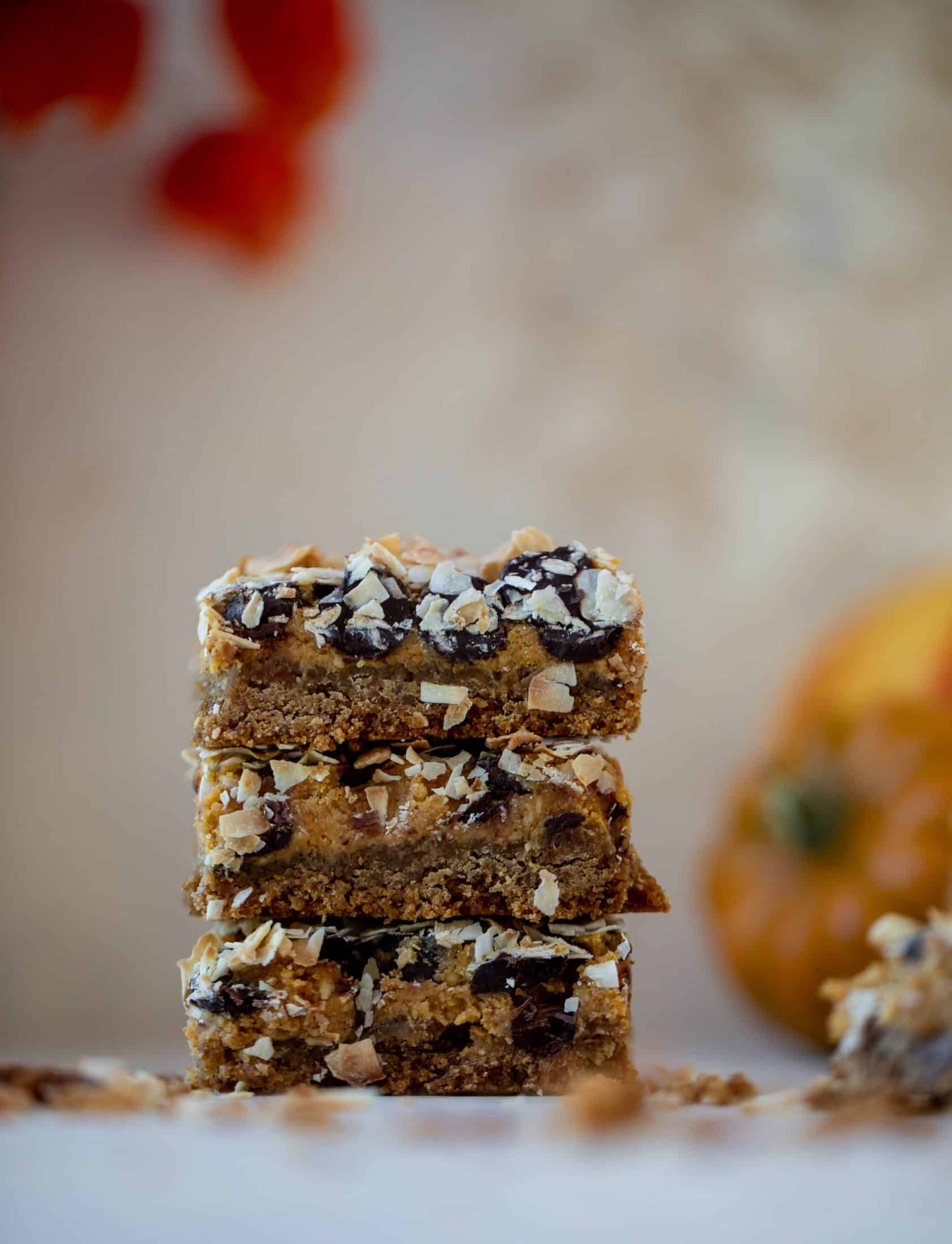 Pumpkin gooey bars are a decadent chocolate, coconut and pumpkin dessert! Crunchy graham crust, gooey pumpkin center and a crisp topping. Yum!