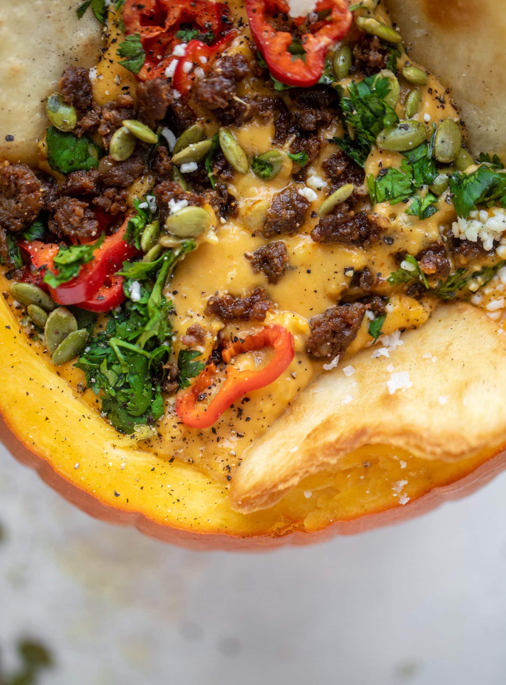 This pumpkin queso fundido is the perfect indulgence for fall. Warm pumpkin queso topped with chroizo, pepitas and jalapeños. It's delish! 