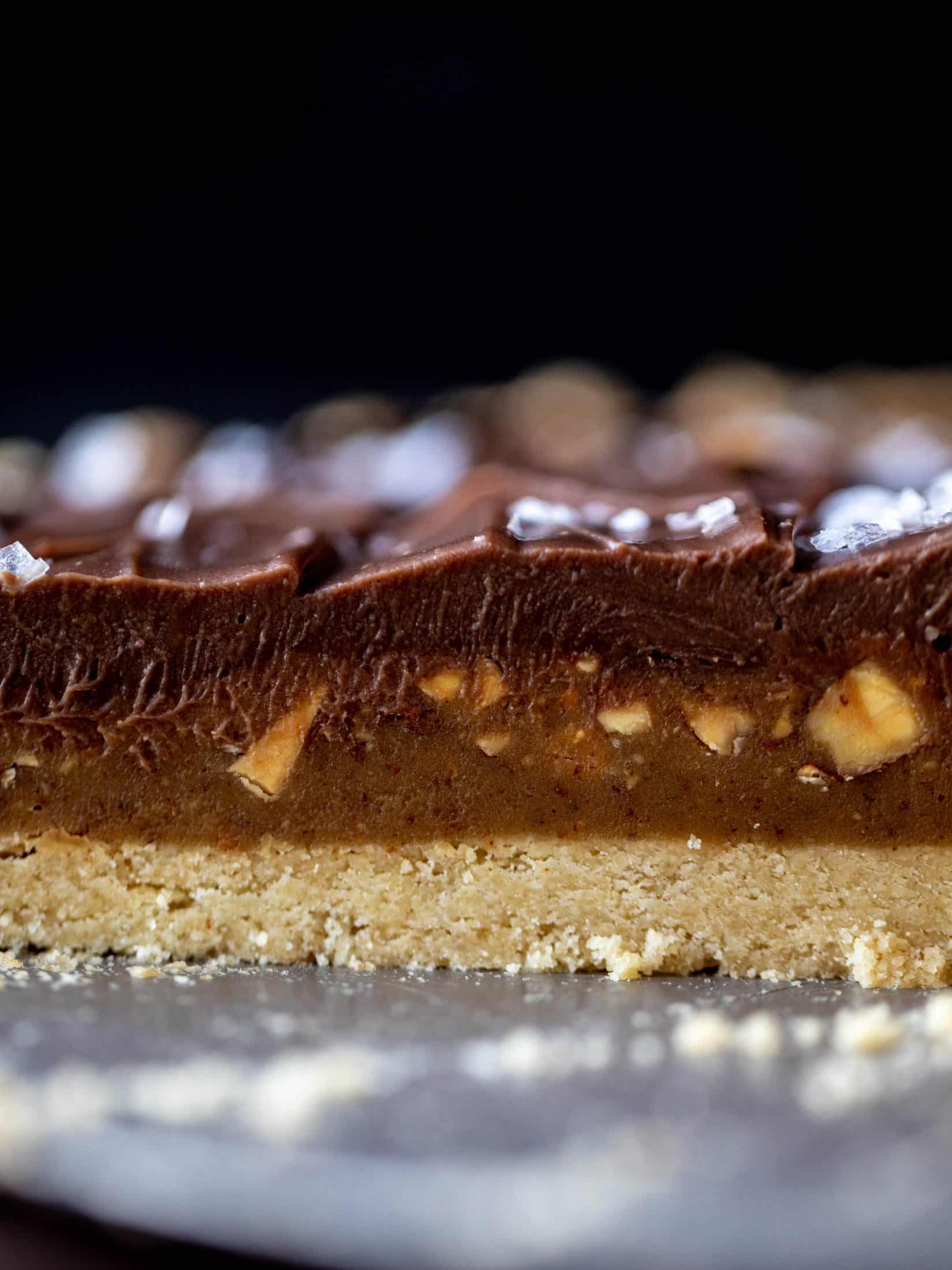This snickers almond tart is made with an almond crust, homemade almond butter caramel and a chocolate ganache. It's to die for!