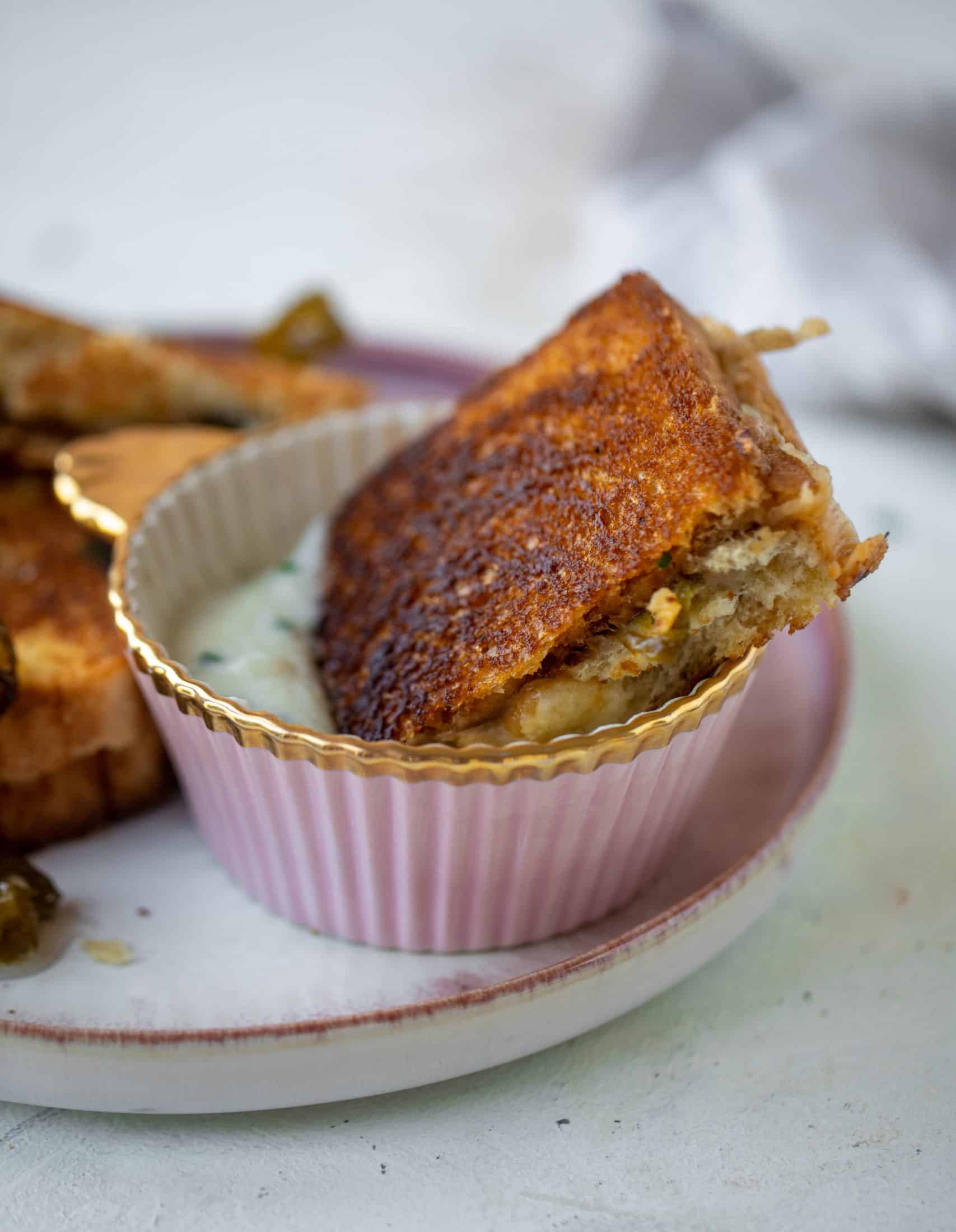 This bacon grilled cheese is filled with sharp cheddar and candied jalapeños! Served alongside a soup dipped for the ultimate comforting meal. 