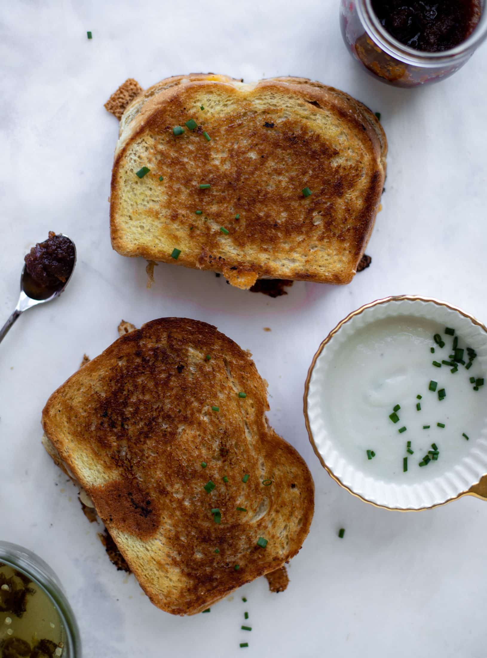 This bacon grilled cheese is filled with sharp cheddar and candied jalapeños! Served alongside a soup dipped for the ultimate comforting meal. 