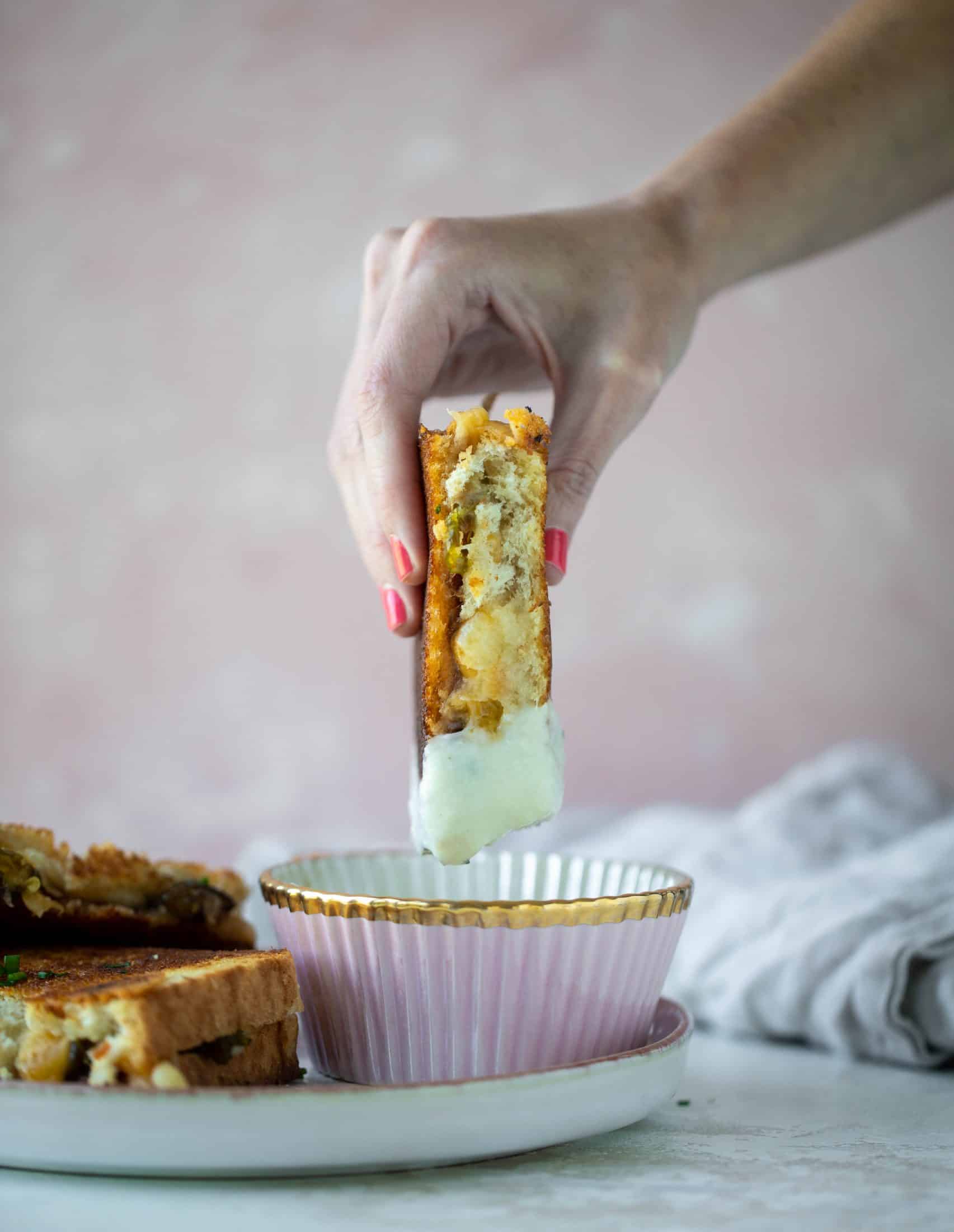 This bacon grilled cheese is filled with sharp cheddar and candied jalapeños! Served alongside a soup dipped for the ultimate comforting meal. 