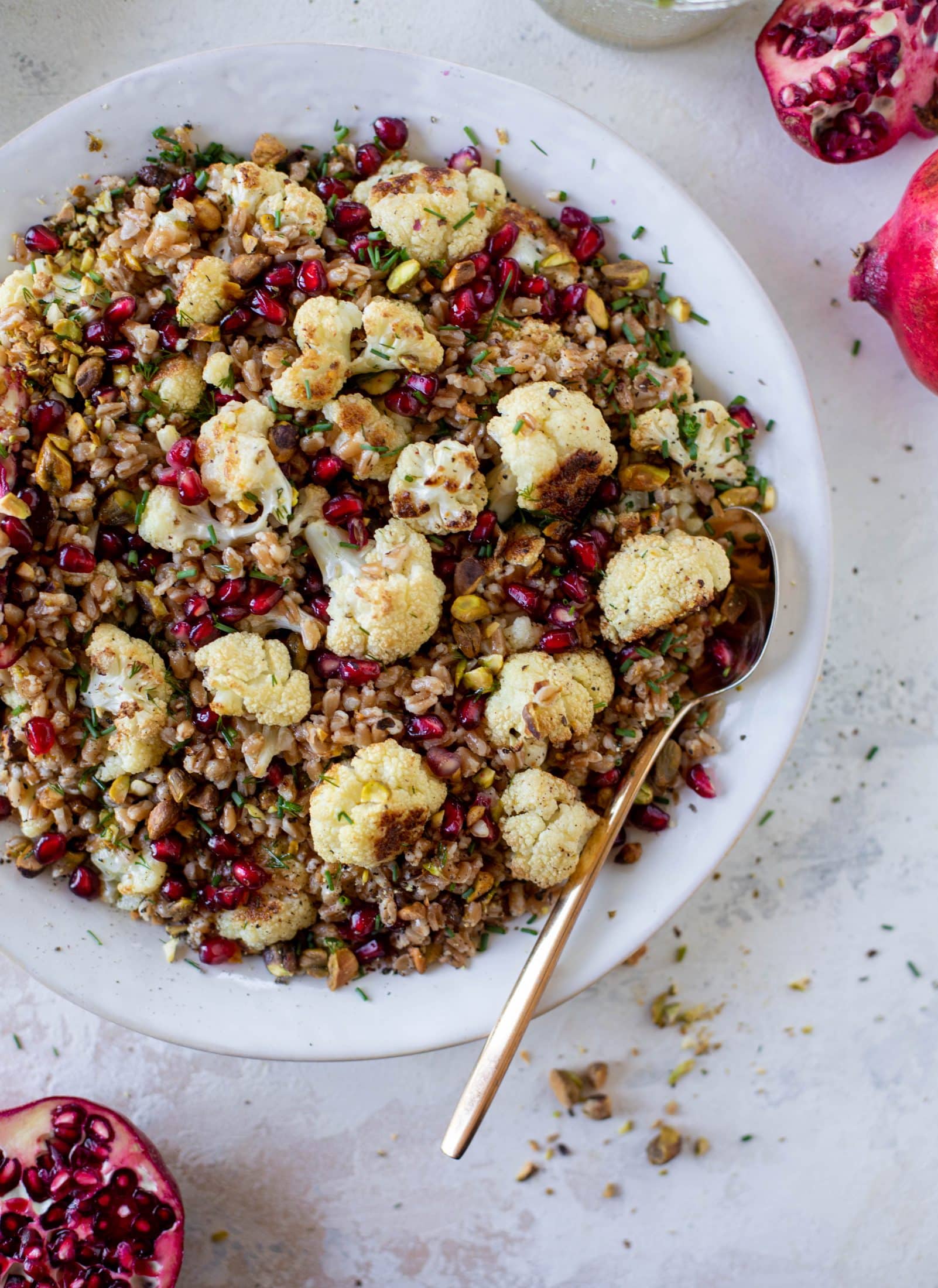 This cauliflower farro salad is filled with roasted cauliflower, pistachios, pomegranates and drizzled with a dill vinaigrette. Delicious!