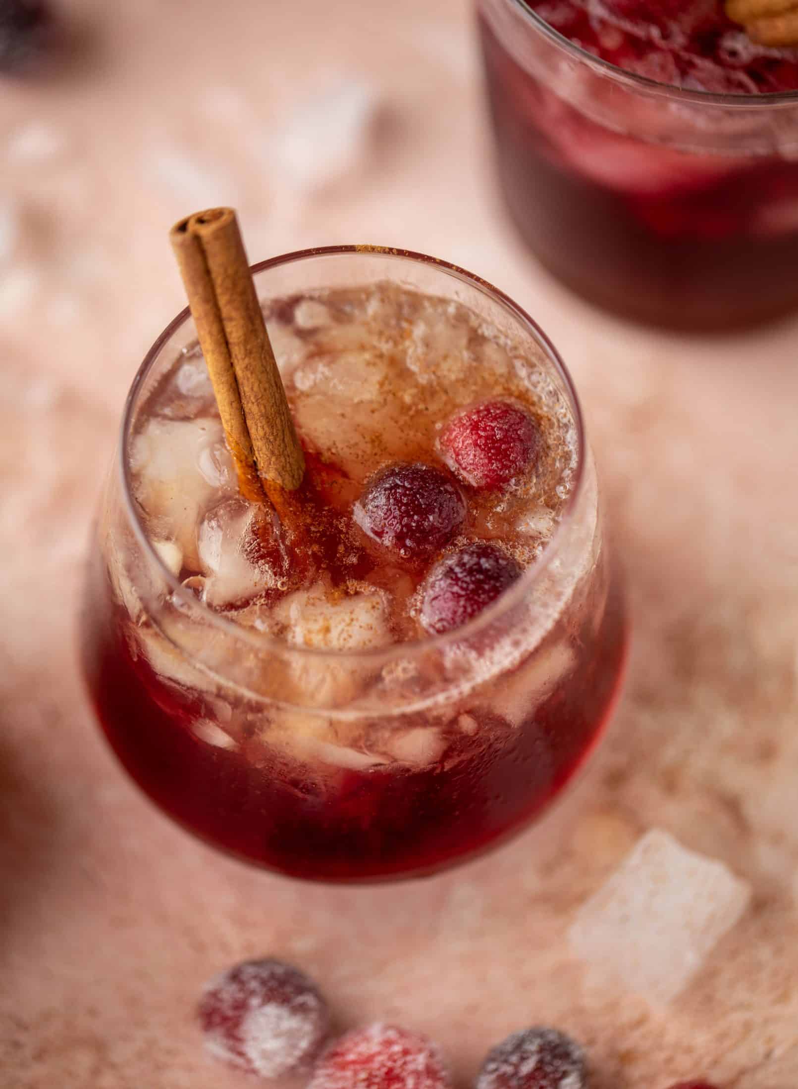 This cranberry cobbler smash is perfect for the holiday season! Bourbon, cinnamon simple syrup and cranberry juice - it's spiced and warming and wonderful.