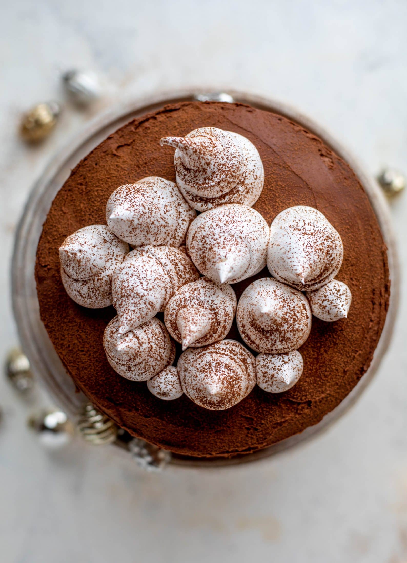 This hot cocoa cake is made with the fudgiest chocolate cake, smothered in chocolate cream cheese frosting and dolloped with whipped marshmallow!