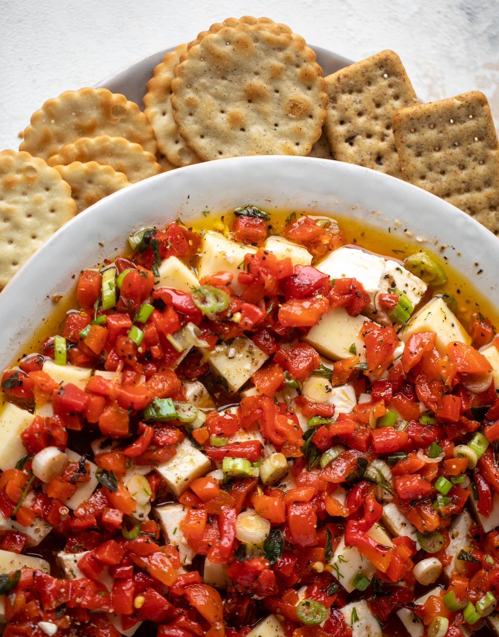 This marinated cheese recipe is perfect for Christmas! Make it ahead and transport it easily to your destination. It's absolutely delicious.