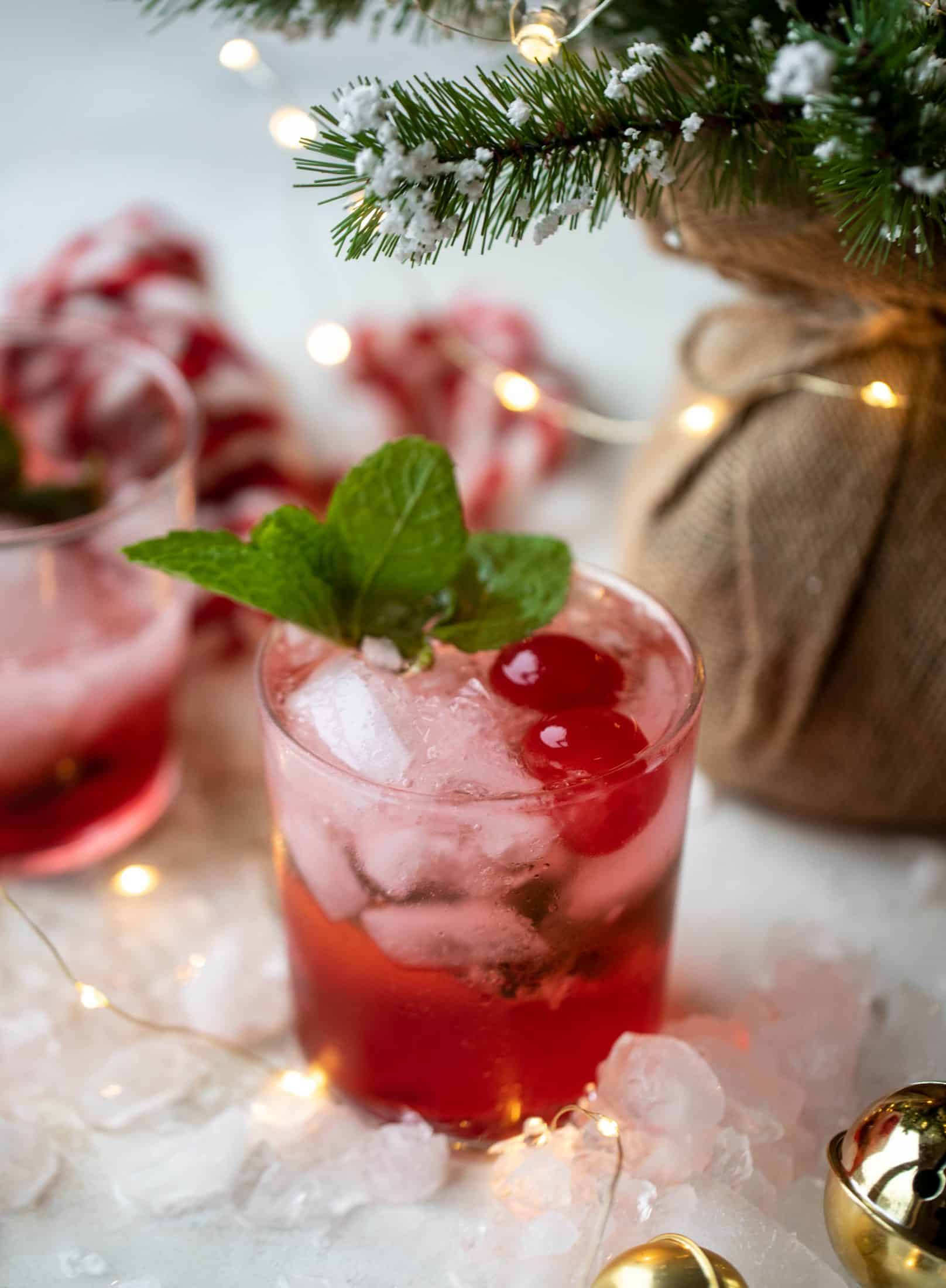 The merry cherry christmas cocktail is here! Vodka and cherries and mint, oh my! This is such a fun drink that can be made into a punch. It's delicious!