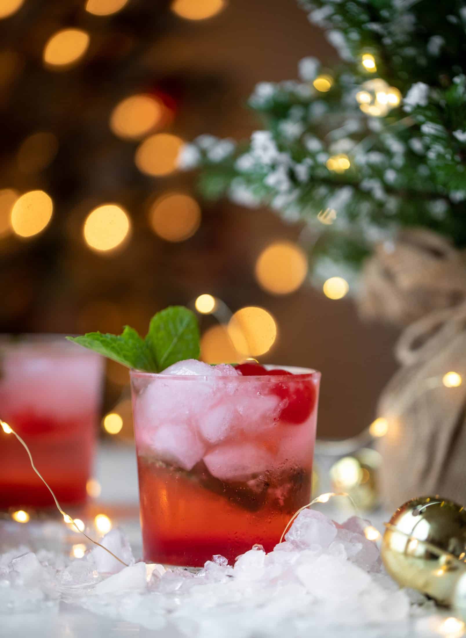 The merry cherry christmas cocktail is here! Vodka and cherries and mint, oh my! This is such a fun drink that can be made into a punch. It's delicious!