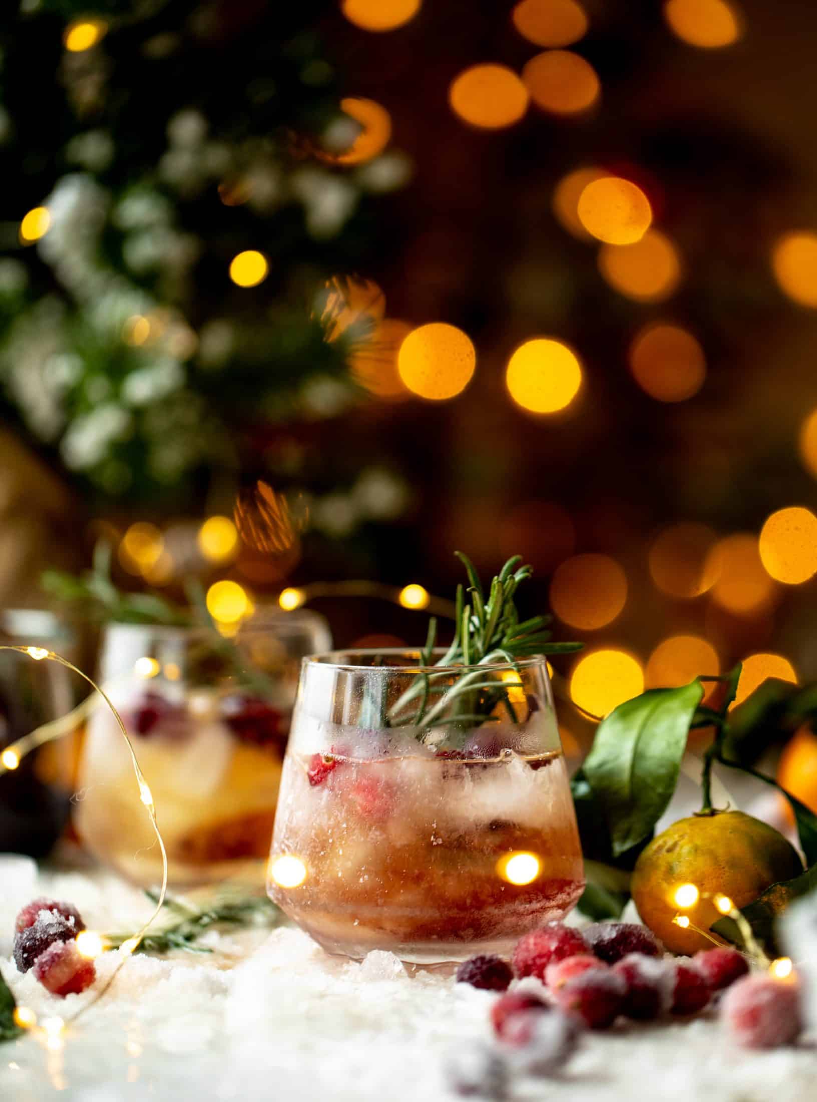 The mistletoe manhattan is a fun holiday spin on the classic manhattan cocktail! Sugared cranberries and rosemary make this super festive.