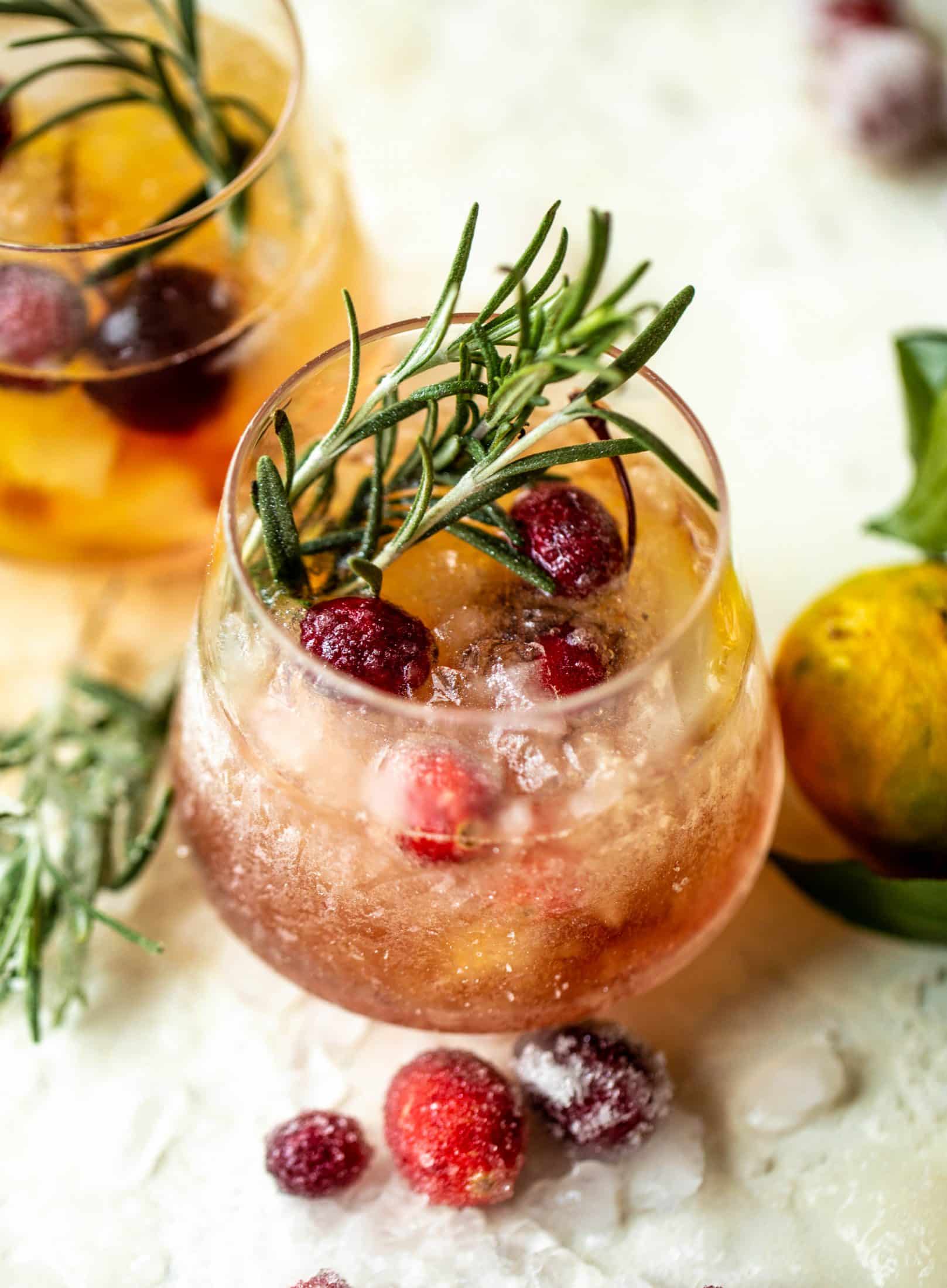 The mistletoe manhattan is a fun holiday spin on the classic manhattan cocktail! Sugared cranberries and rosemary make this super festive.
