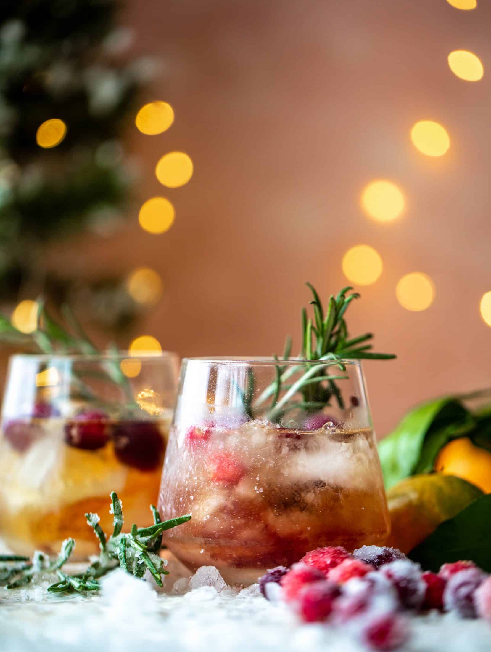 The mistletoe manhattan is a fun holiday spin on the classic manhattan cocktail! Sugared cranberries and rosemary make this super festive.