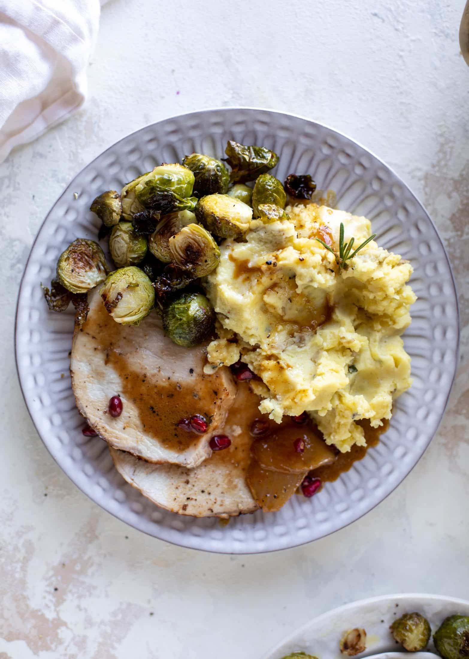 This pork loin roast is perfect for the holiday or winter season! Pomegranate and cider glazed, it's wonderful! Serve with smashed rosemary potatoes.