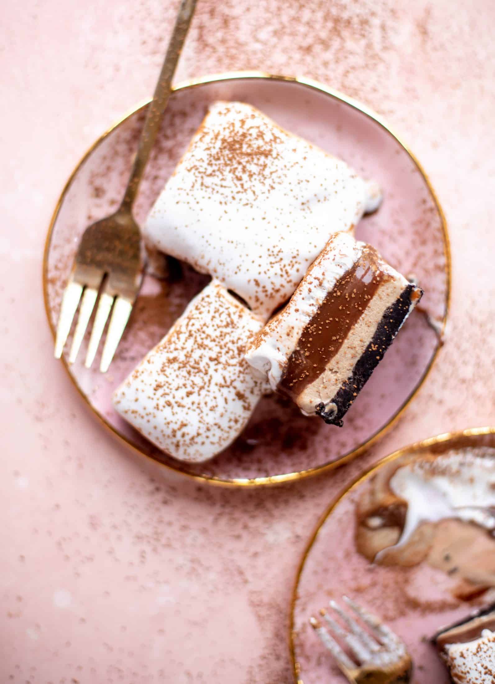 This frozen chocolate cookie dessert is a twist on the classic 90s recipe! Cookie crust, ice cream, homemade hot fudge and whipped cream. It's amazing!