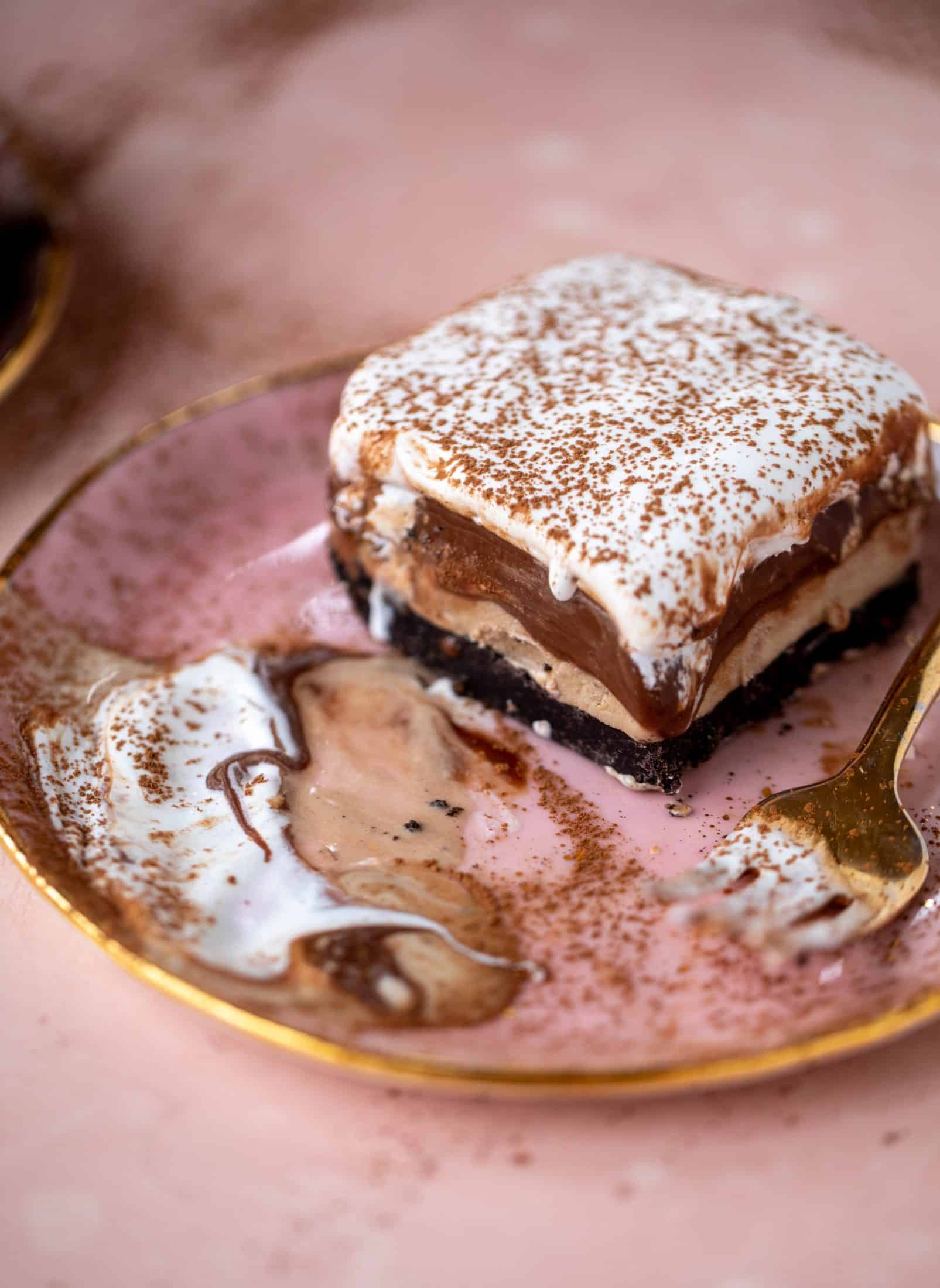 This frozen chocolate cookie dessert is a twist on the classic 90s recipe! Cookie crust, ice cream, homemade hot fudge and whipped cream. It's amazing!
