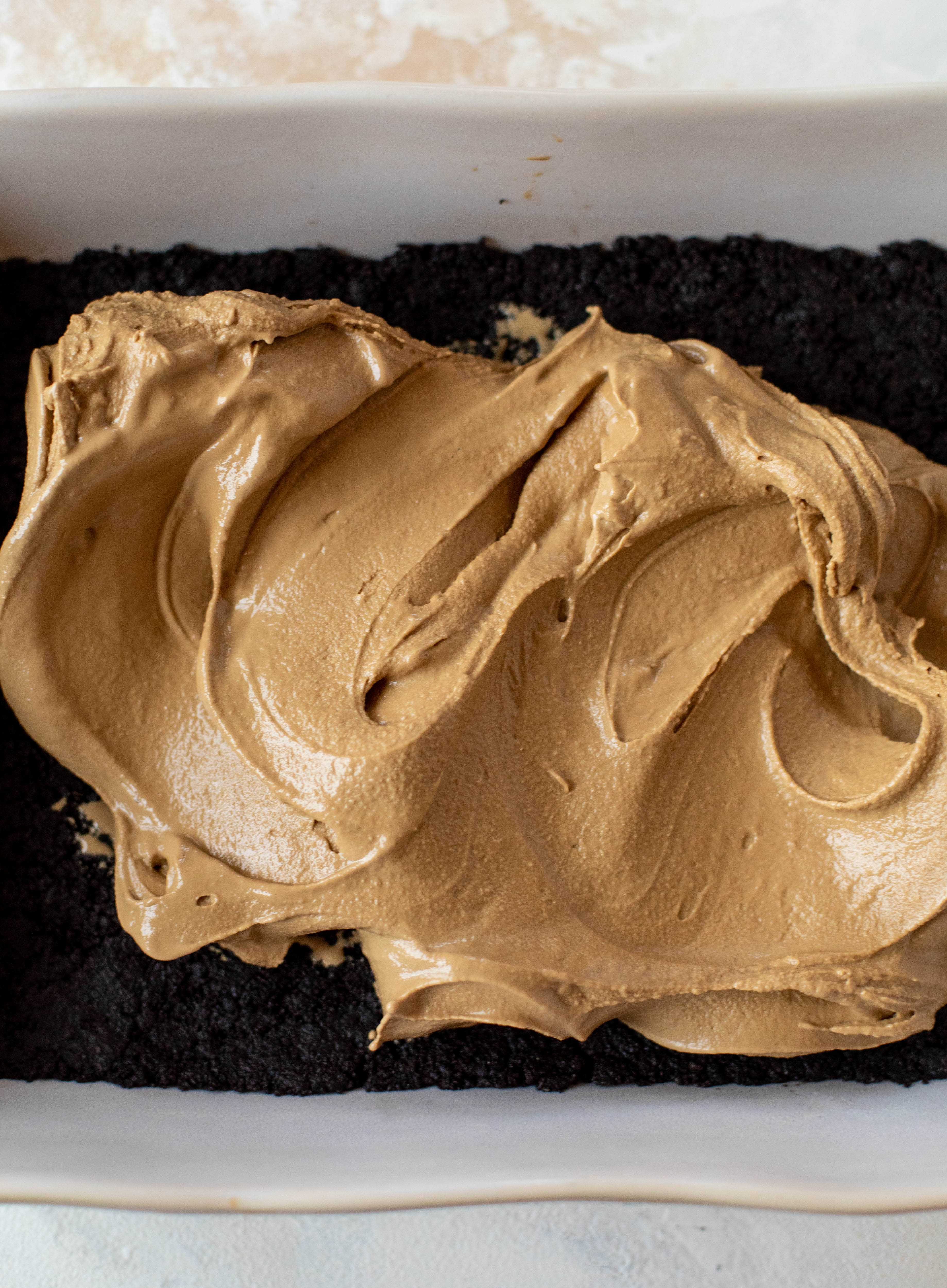 This frozen chocolate cookie dessert is a twist on the classic 90s recipe! Cookie crust, ice cream, homemade hot fudge and whipped cream. It's amazing!