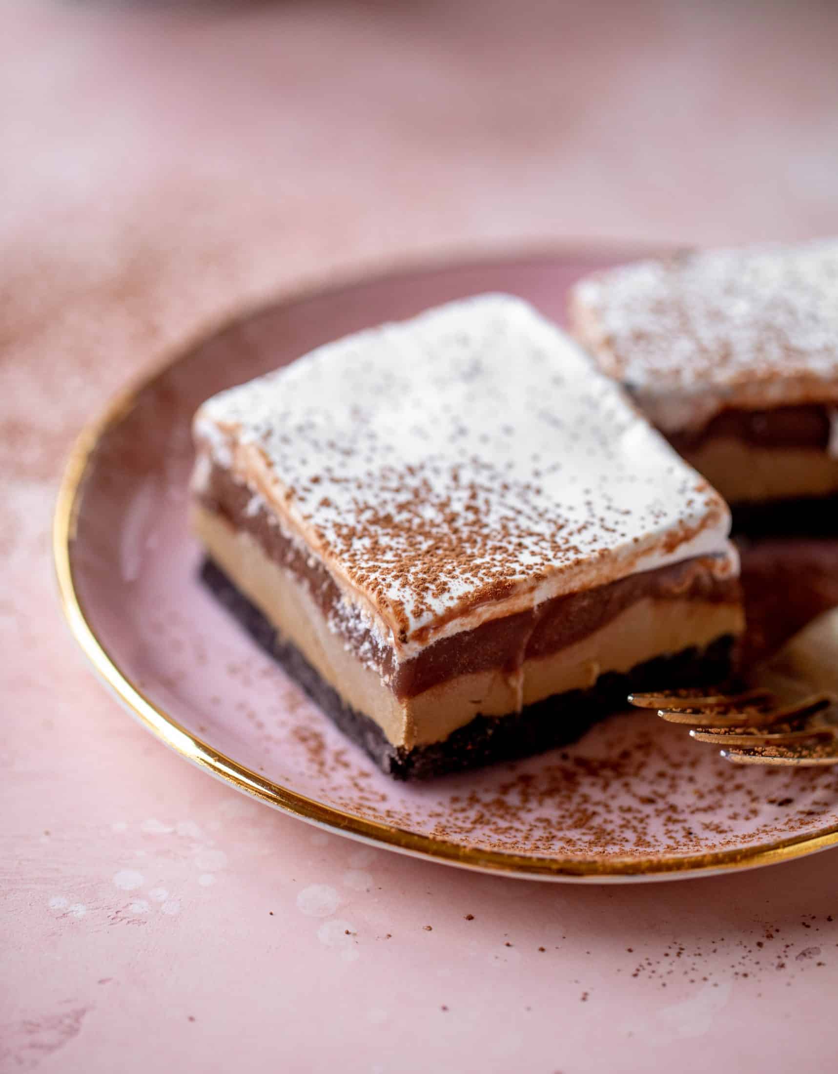 This frozen chocolate cookie dessert is a twist on the classic 90s recipe! Cookie crust, ice cream, homemade hot fudge and whipped cream. It's amazing!