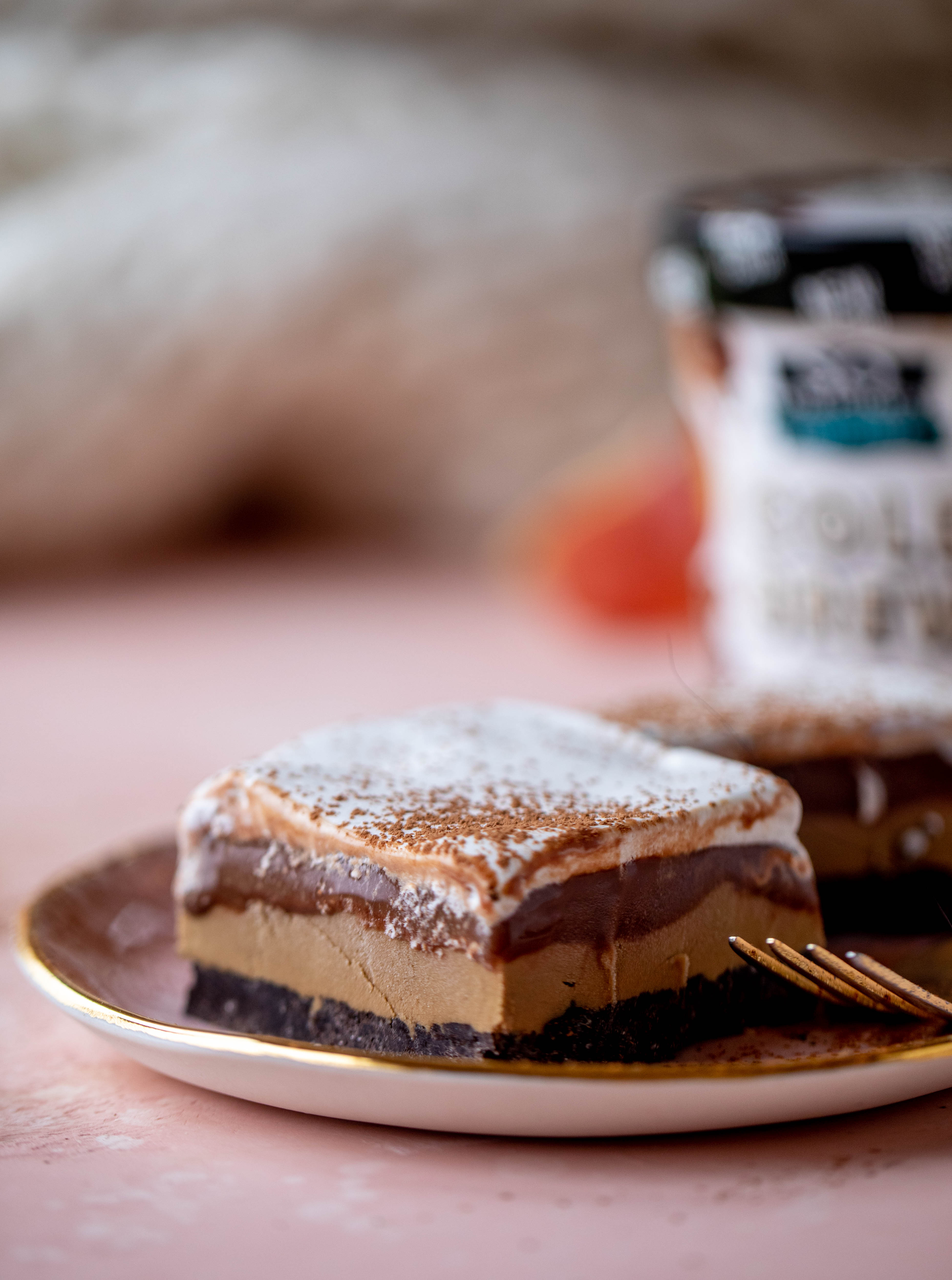 This frozen chocolate cookie dessert is a twist on the classic 90s recipe! Cookie crust, ice cream, homemade hot fudge and whipped cream. It's amazing!