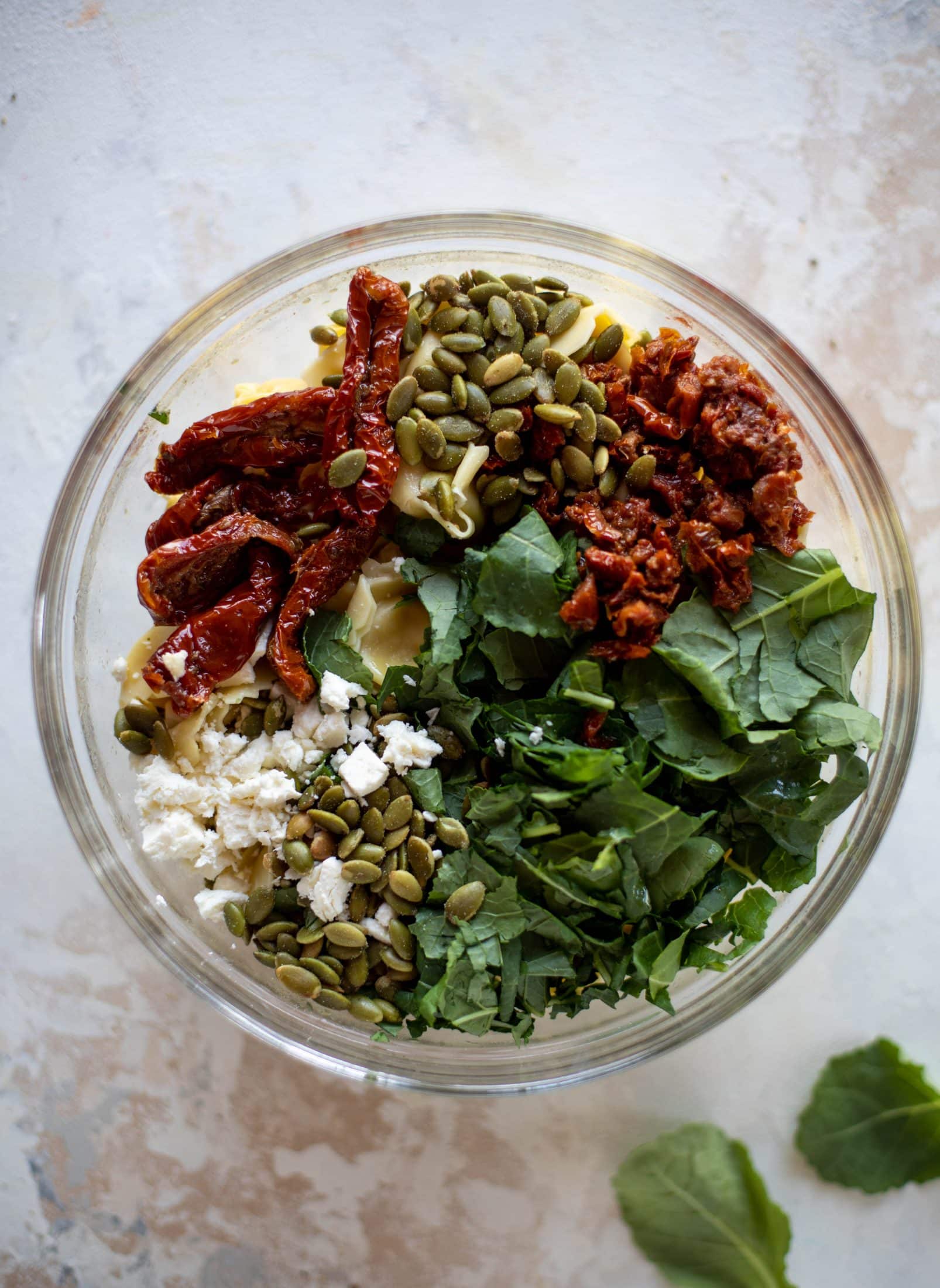This cilantro lime tortellini salad is loaded with flavor! Served warm or cold, it has pepitas, sun dried tomatoes and crumbled feta. It's ridiculously good! 