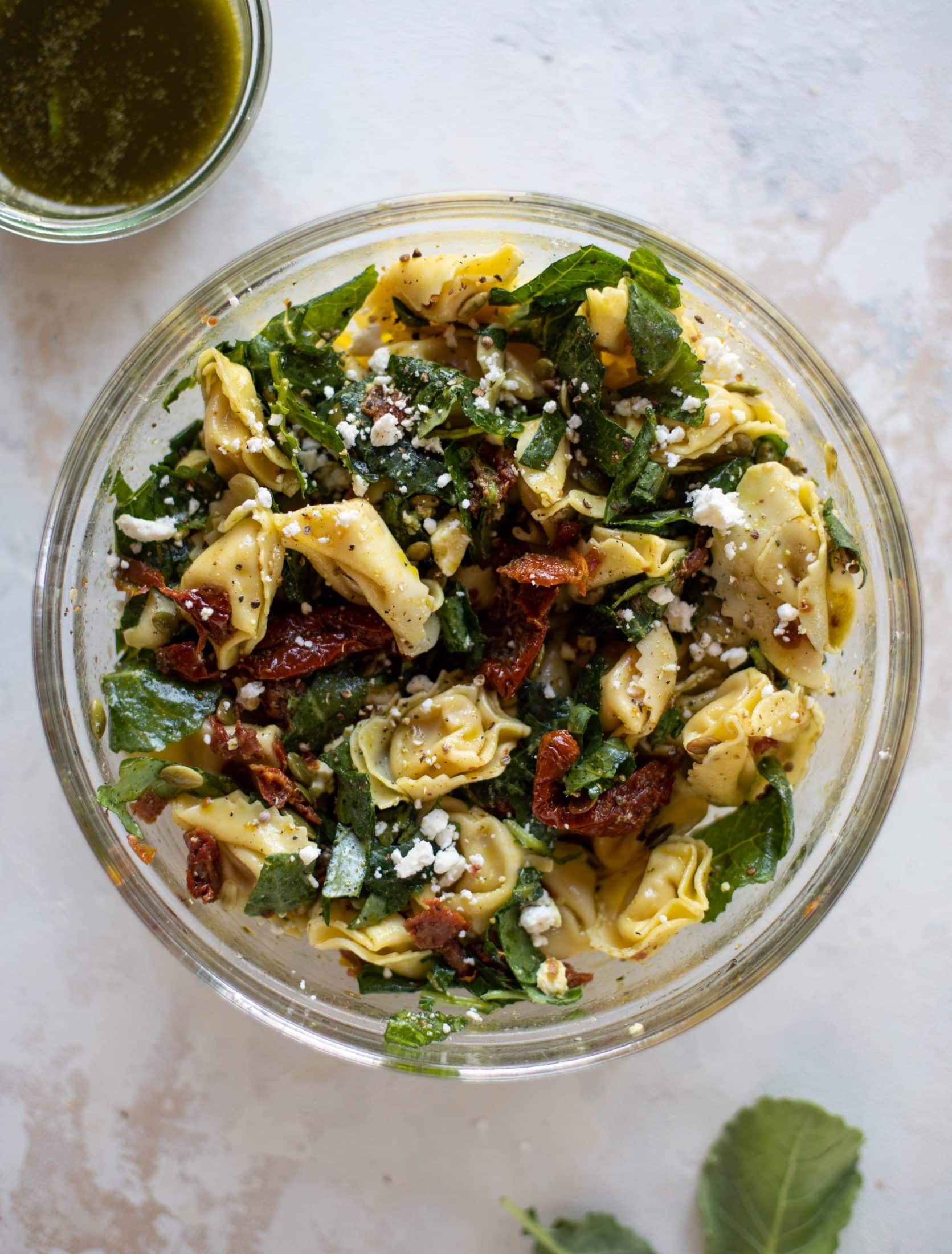 This cilantro lime tortellini salad is loaded with flavor! Served warm or cold, it has pepitas, sun dried tomatoes and crumbled feta. It's ridiculously good! 