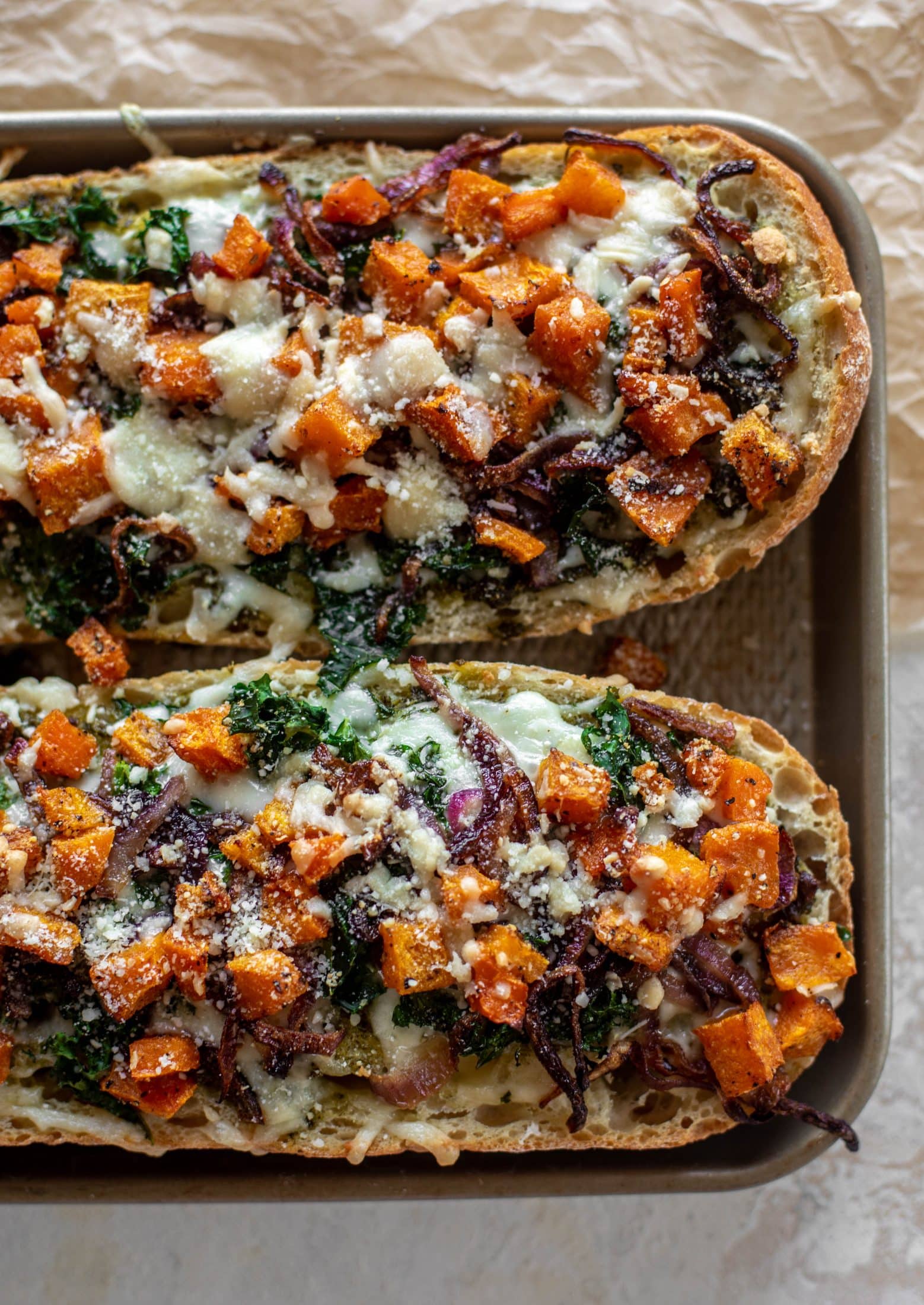 These butternut squash french breads have so much flavor. Pesto, caramelized onions, kale, roasted butternut and tons of fontina cheese. Delicious! 