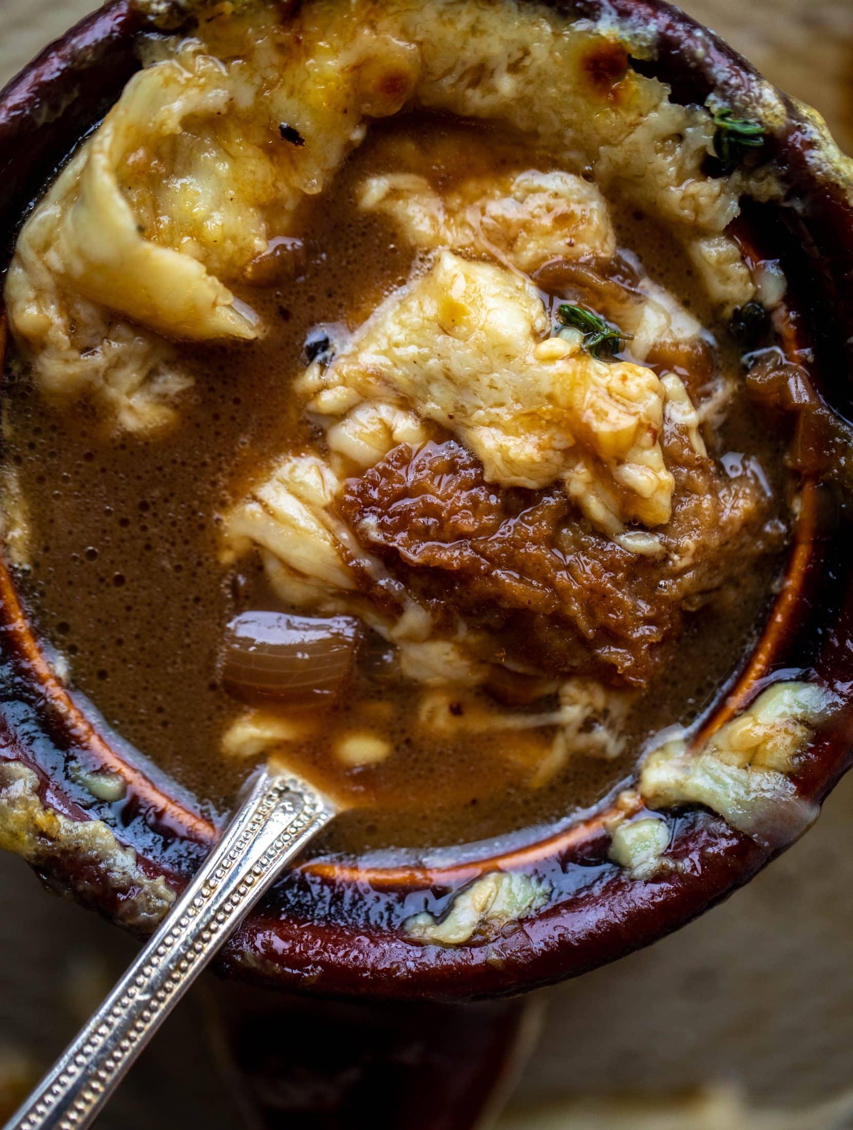 My favorite french onion soup starts with bourbon caramelized onions! Adorable heart croutons and tons of gruyere take it over the top.