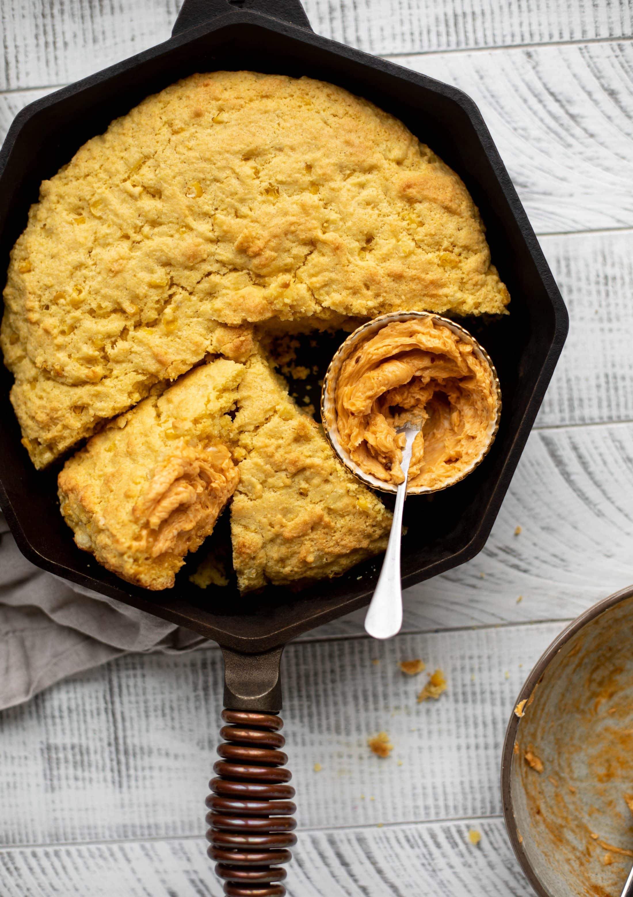This skillet cornbread is so fluffy and delicious! Serve it hot from the oven with chipotle honey butter. It makes a great appetizer or side dish. 