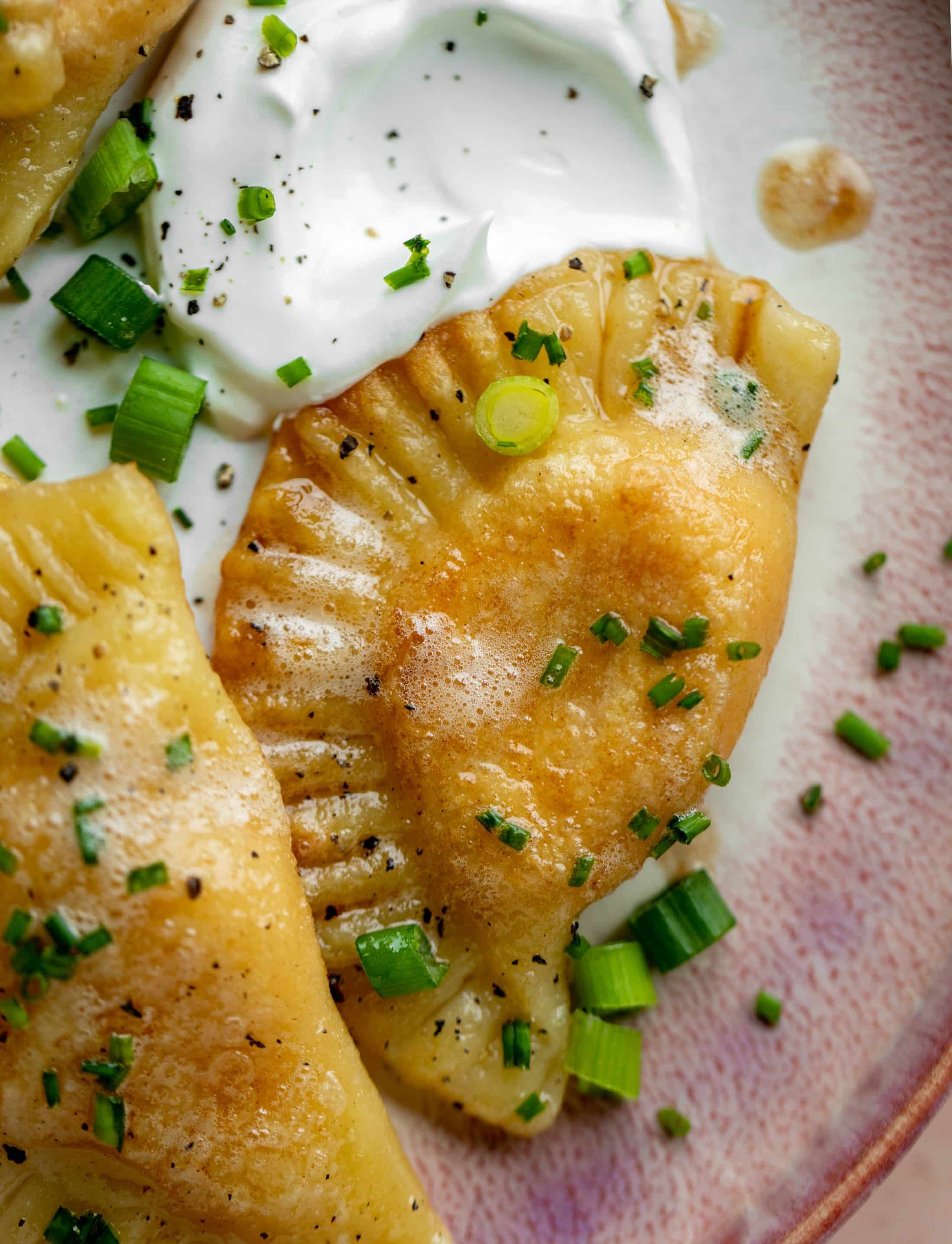 The most delicious sweet potato pierogi recipe! Roasted sweet potato and fontina cheese in pillowy dough. Make sure to serve with brown butter!