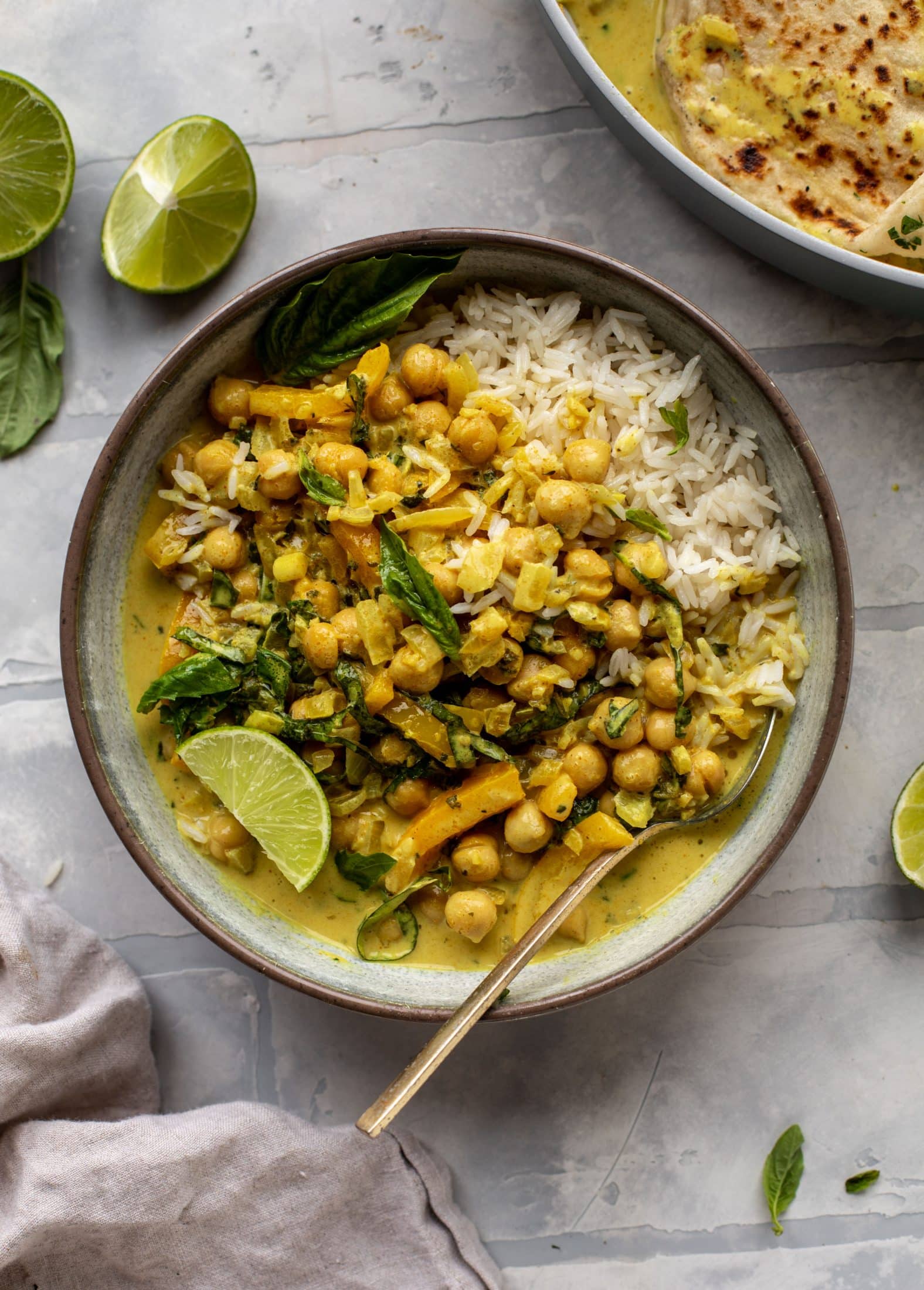 This basil chickpea coconut curry comes together in 20 minutes! Serve with jasmine rice or your favorite naan, or both! So easy and flavorful.