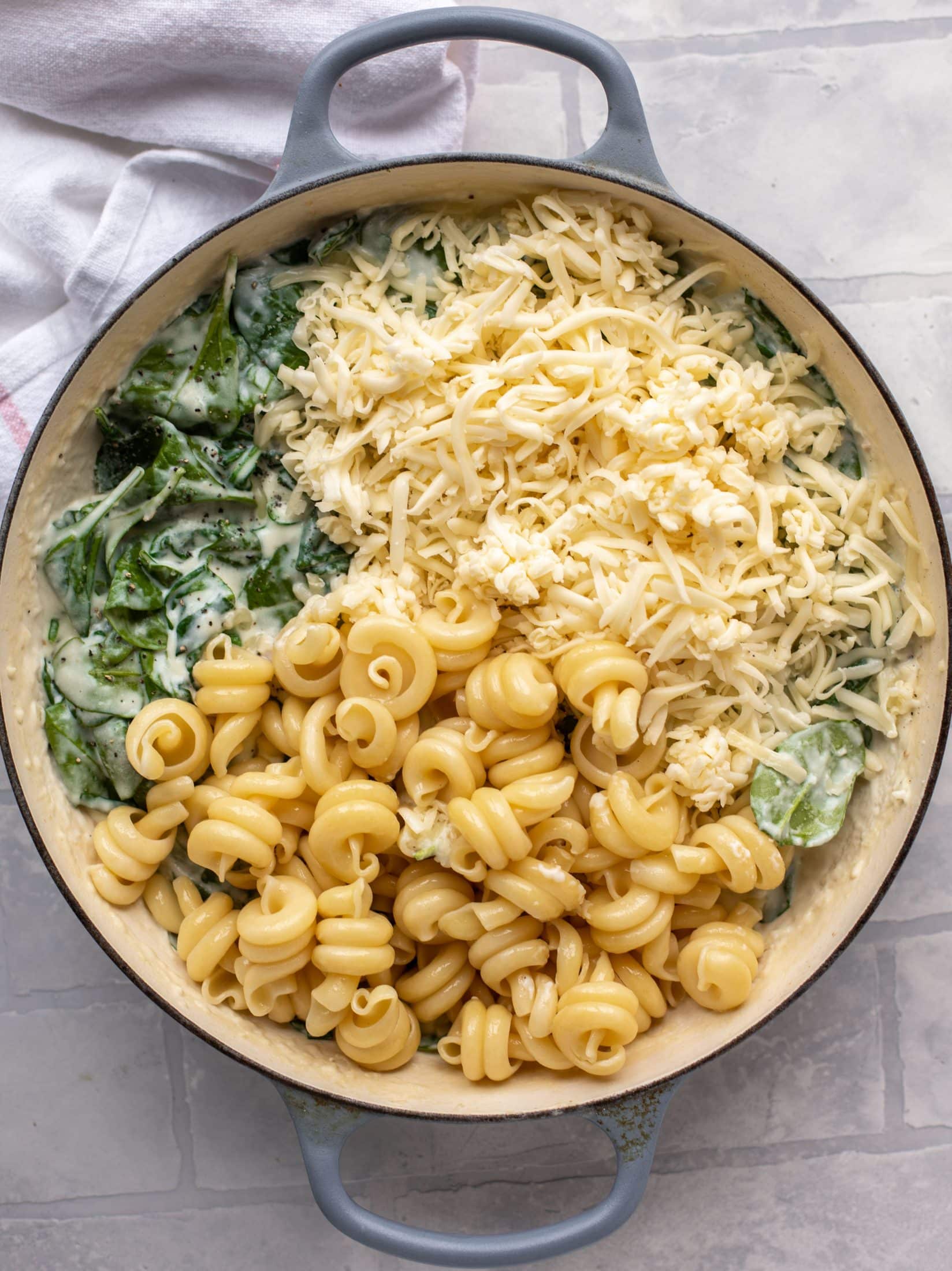 This creamed spinach mac and cheese is a dreamy, cheesy mac and cheese dish with tons of fresh baby spinach! Super comforting and flavorful. 
