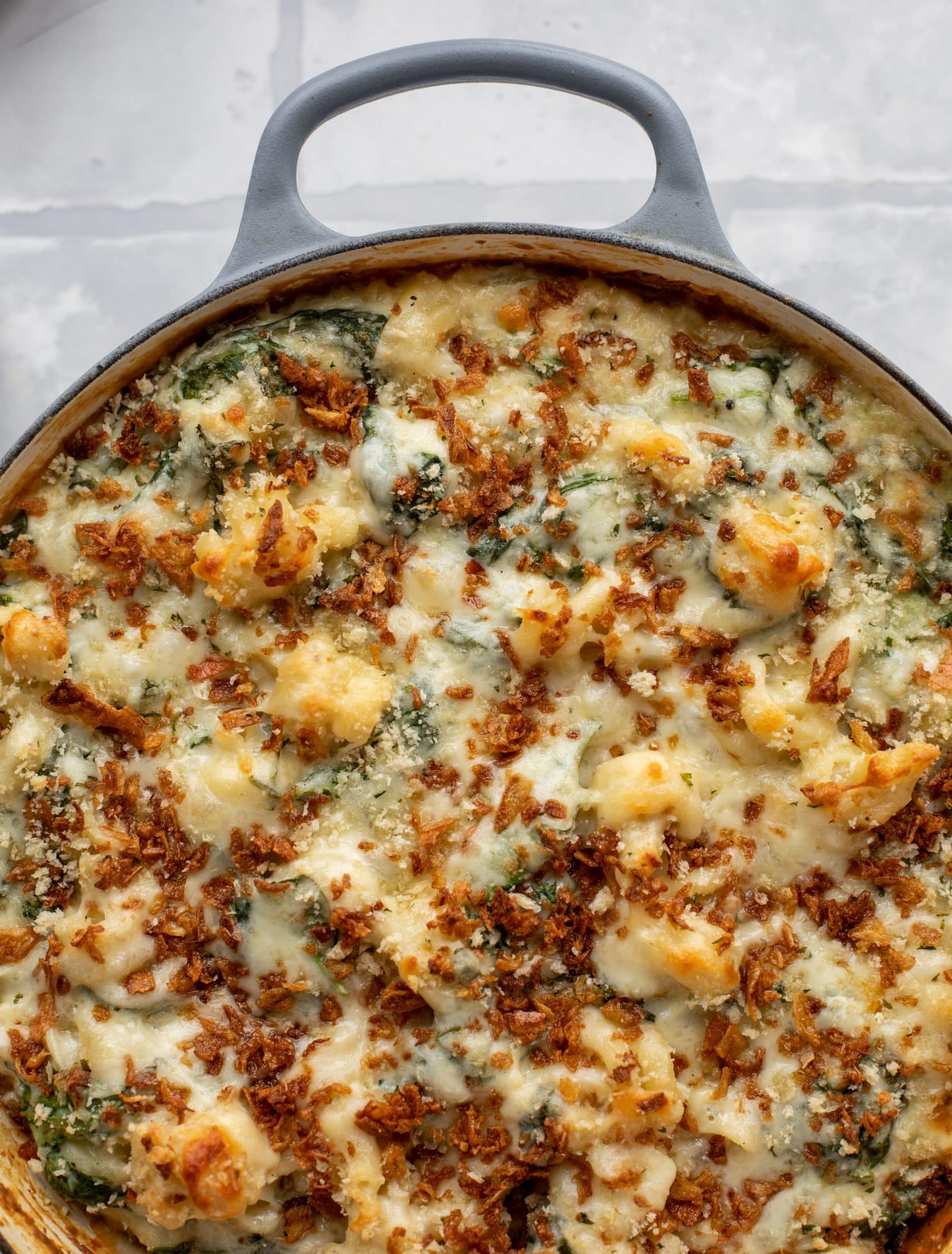 This creamed spinach mac and cheese is a dreamy, cheesy mac and cheese dish with tons of fresh baby spinach! Super comforting and flavorful. 